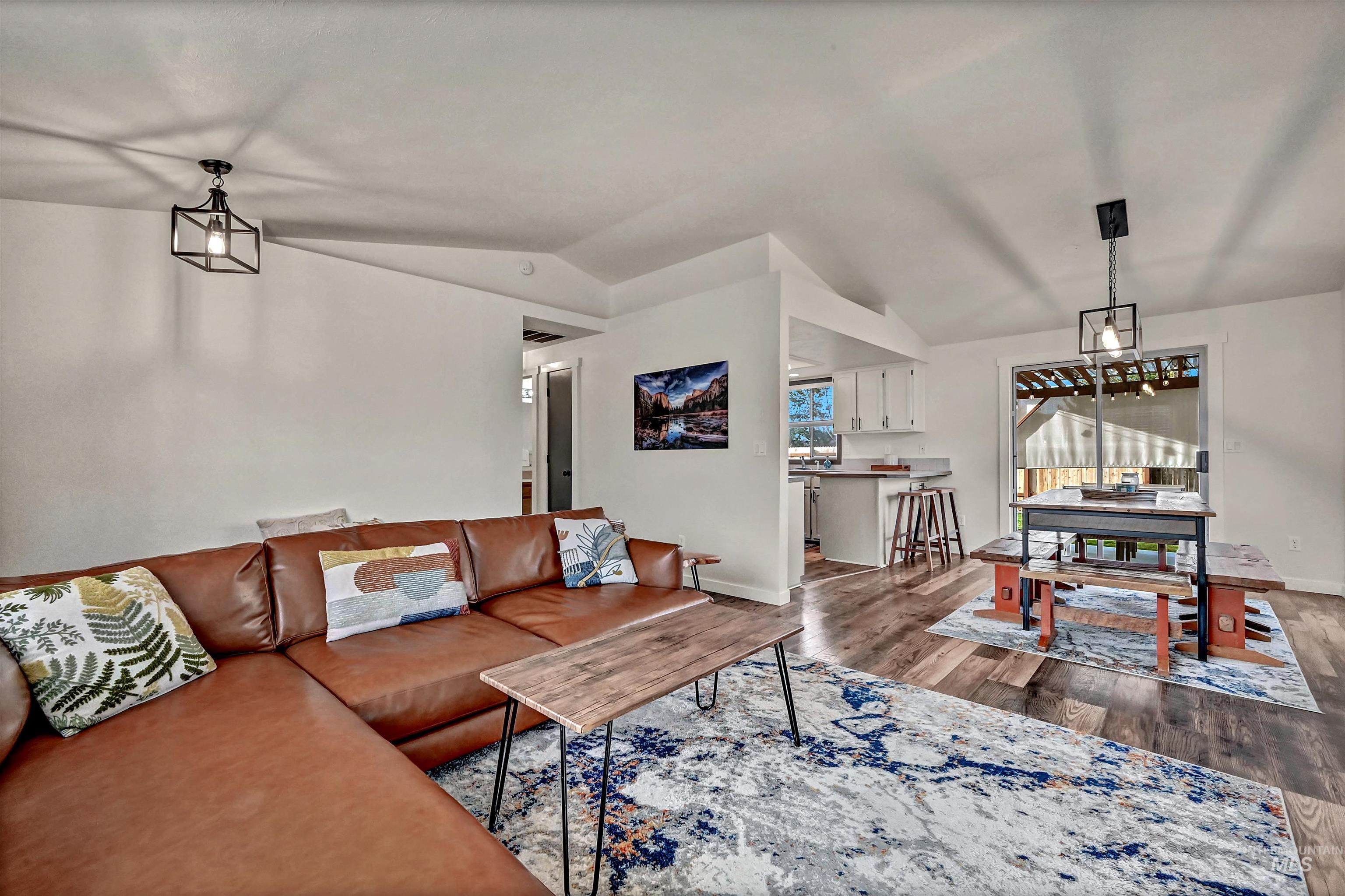 Living area featuring lofted ceiling and wood finished floors
