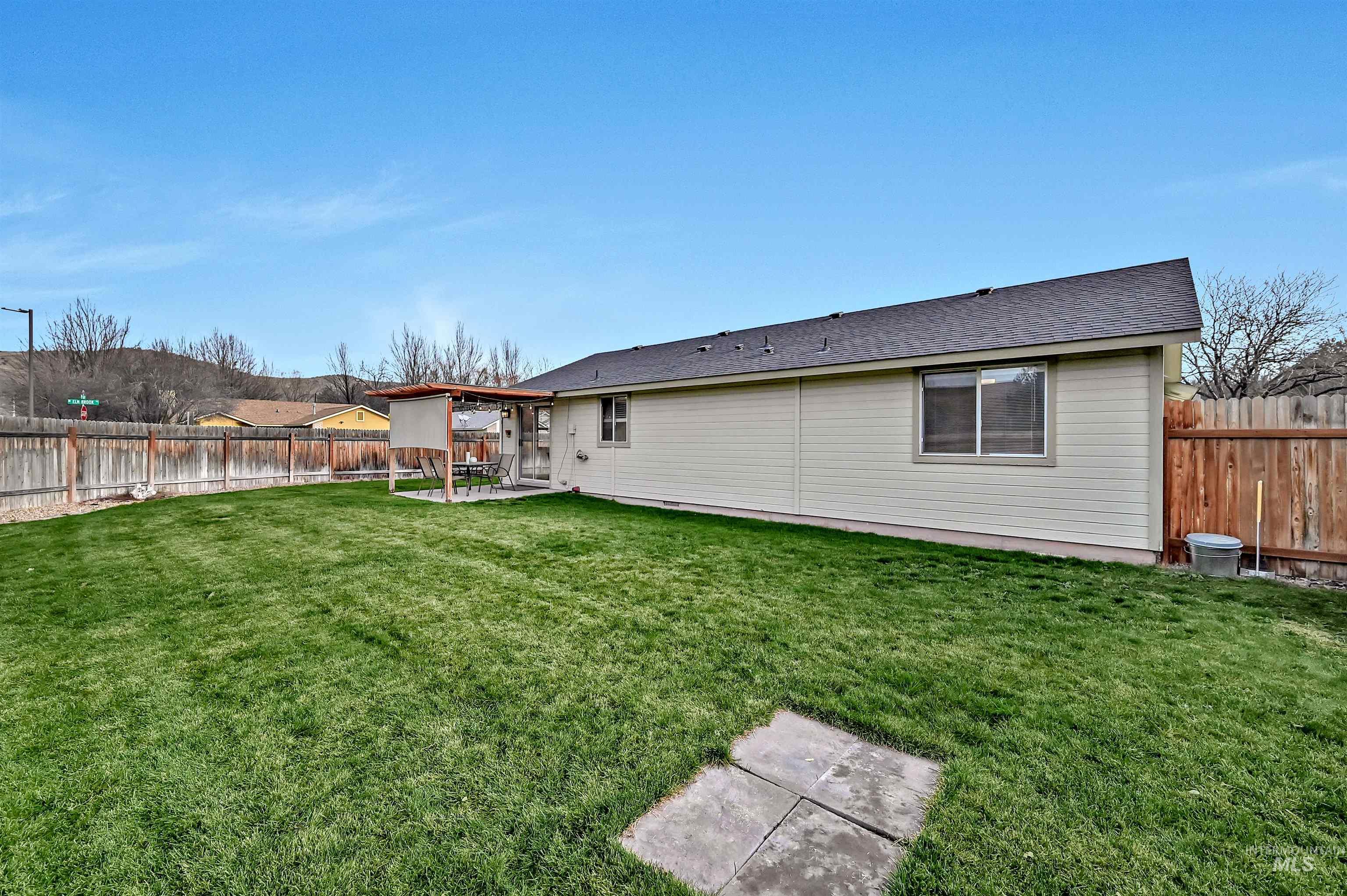 Rear view of house with a patio, a fenced backyard, roof with shingles, and a gazebo