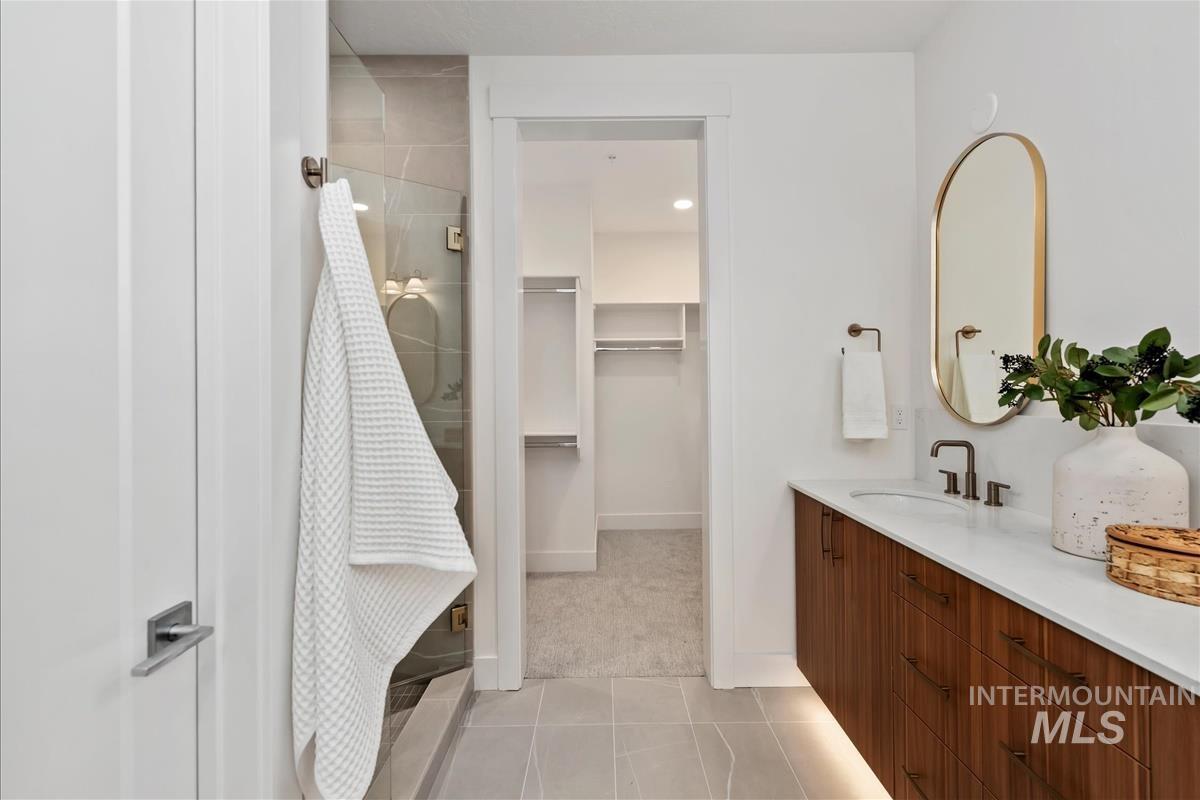 Floating wood-finish vanity with an undermount sink and quartz countertop