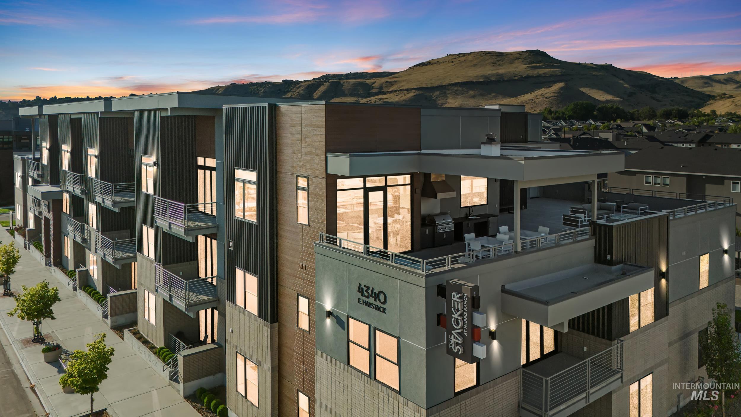 Property at dusk featuring a mountain view and a residential view