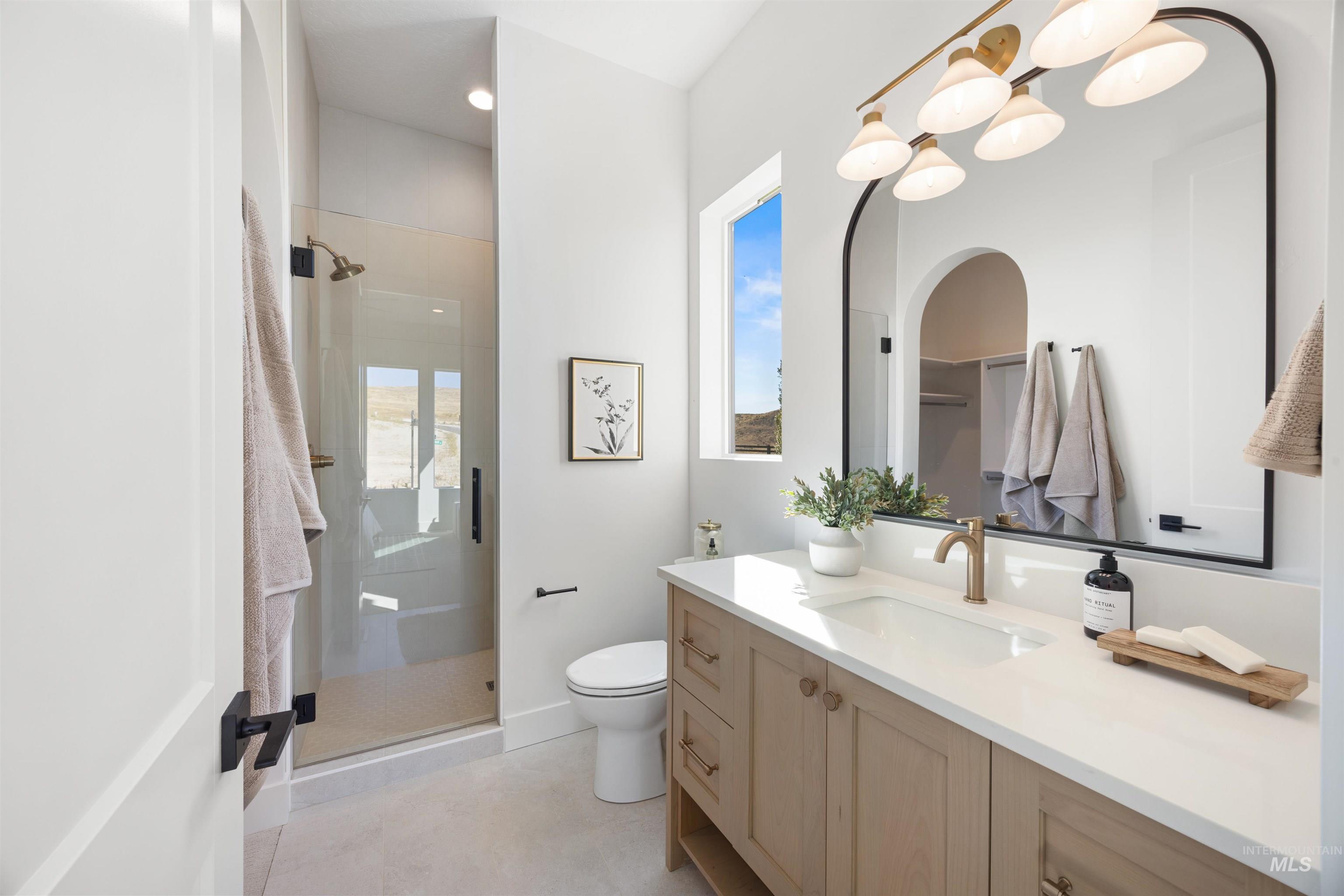 Full bath with a shower stall, vanity, light tile patterned floors, and recessed lighting