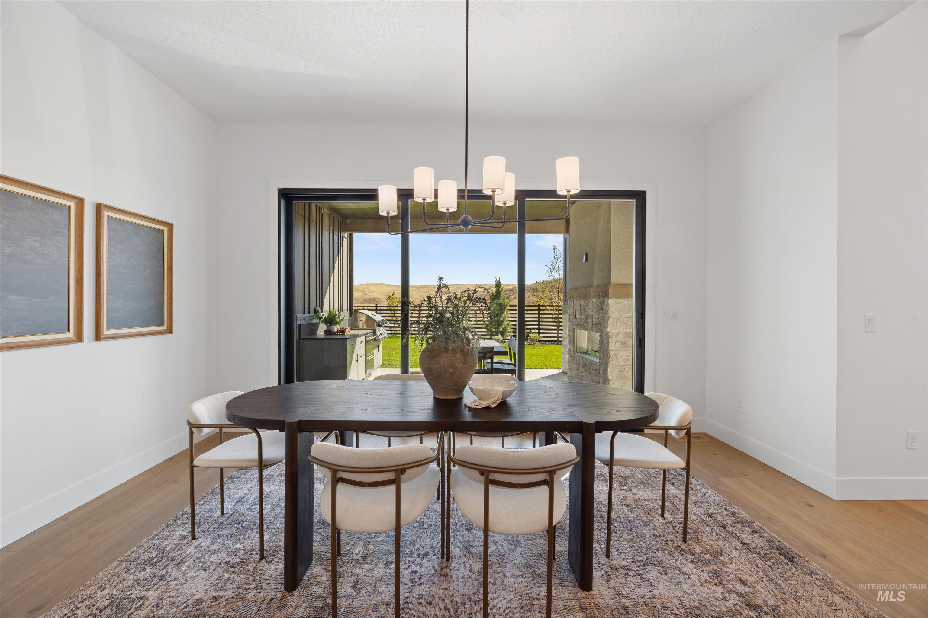 Dining space featuring light wood finished floors and a chandelier