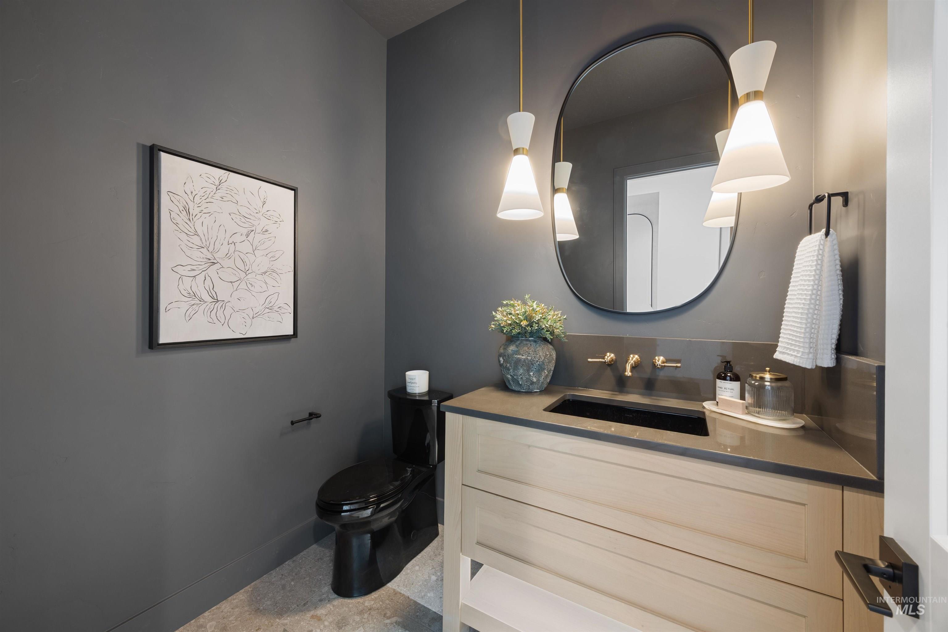 Bathroom featuring vanity and baseboards