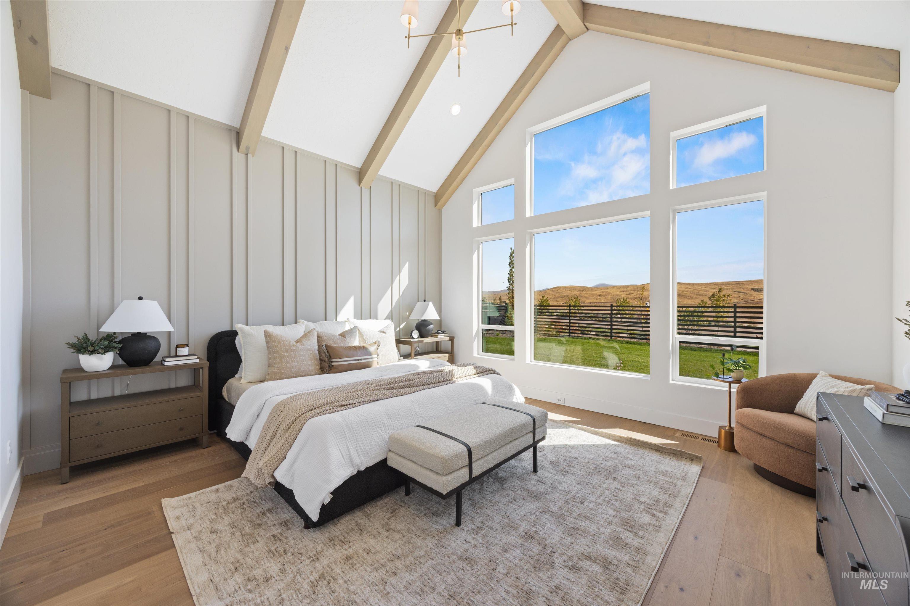 Bedroom featuring high vaulted ceiling, beam ceiling, and light wood-style floors
