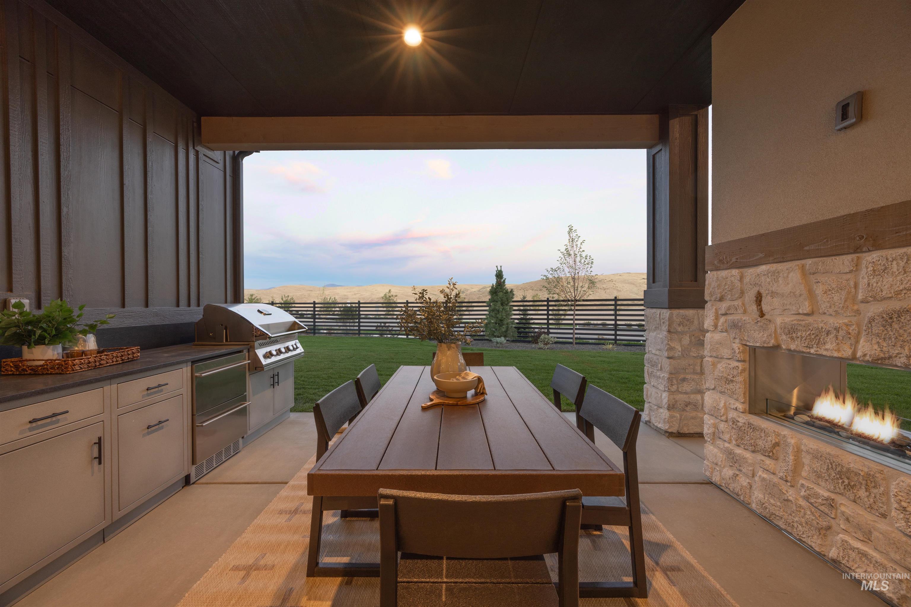 Fenced backyard with area for grilling, outdoor dining area, and a patio area