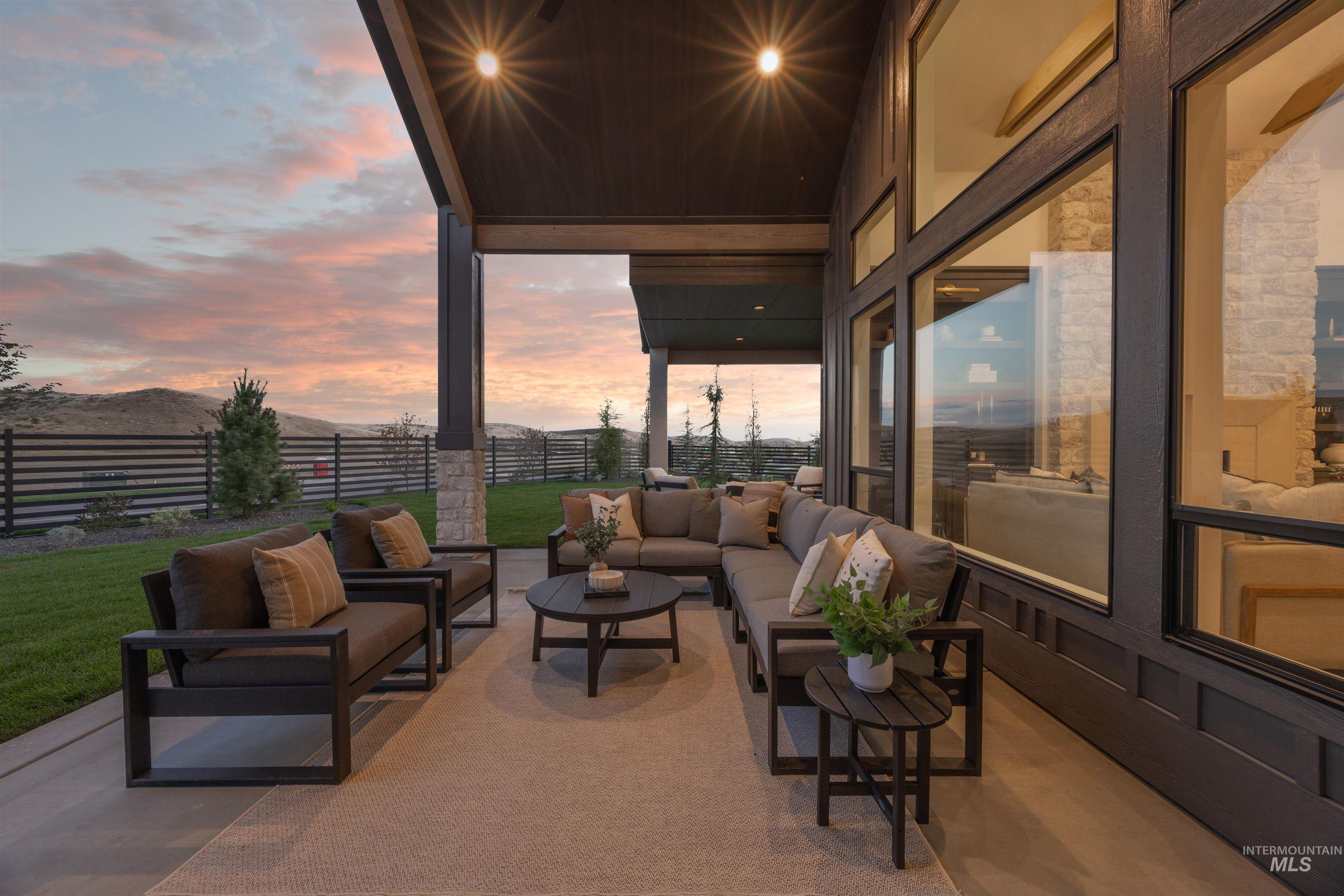 Fenced backyard featuring a patio, an outdoor living space, and a mountain view