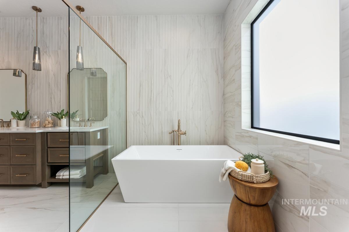 Full bath with vanity and a freestanding bath