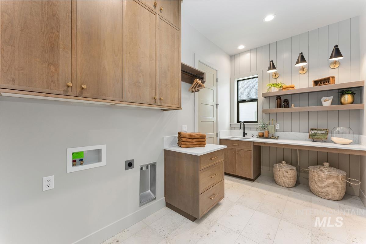 Laundry room with hookup for an electric dryer, recessed lighting, cabinet space, light flooring, and hookup for a washing machine