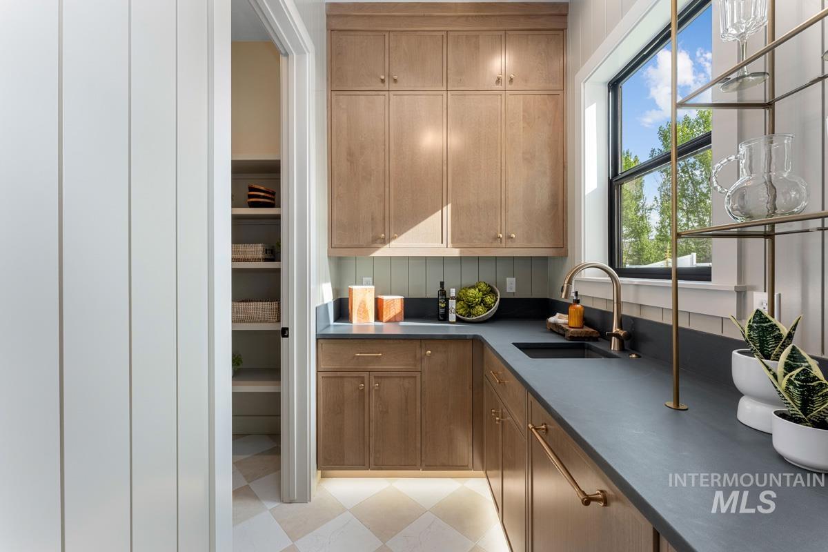 Kitchen with dark countertops and wood finish cabinets