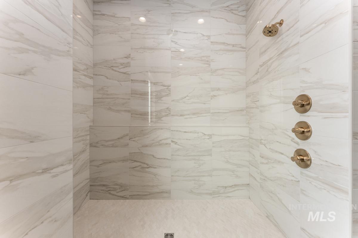Bathroom with a marble finish shower