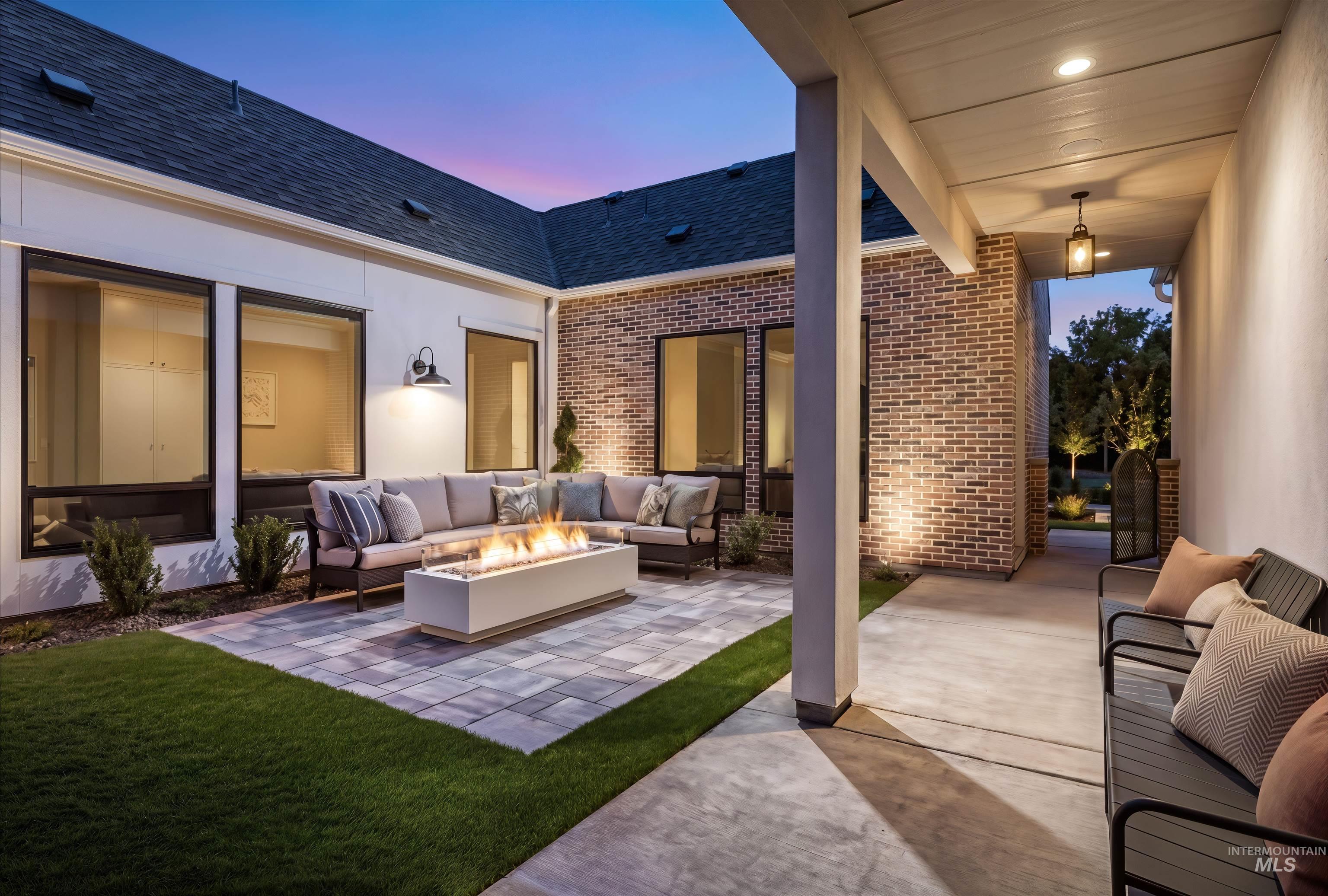 Exterior patio featuring a modern fire pit, paver patio, and covered porch with bench seating
