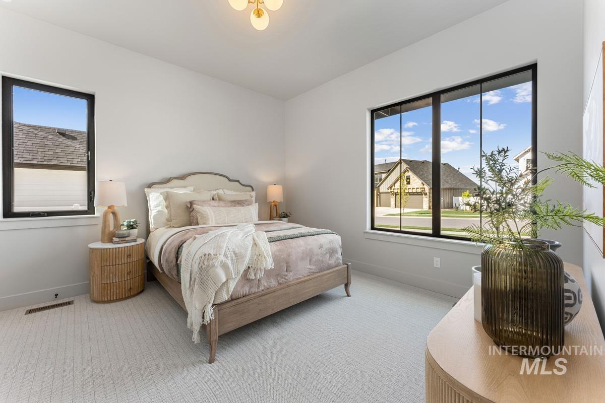 Bedroom with light carpet and baseboards