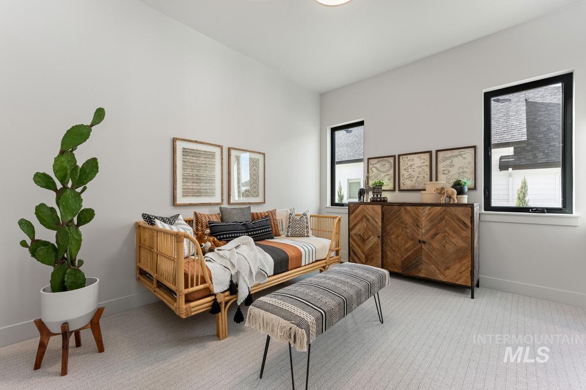 Bedroom featuring light colored carpet and baseboards