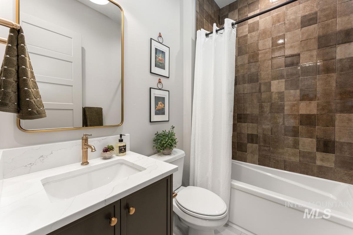 Bathroom featuring vanity and shower / tub combo