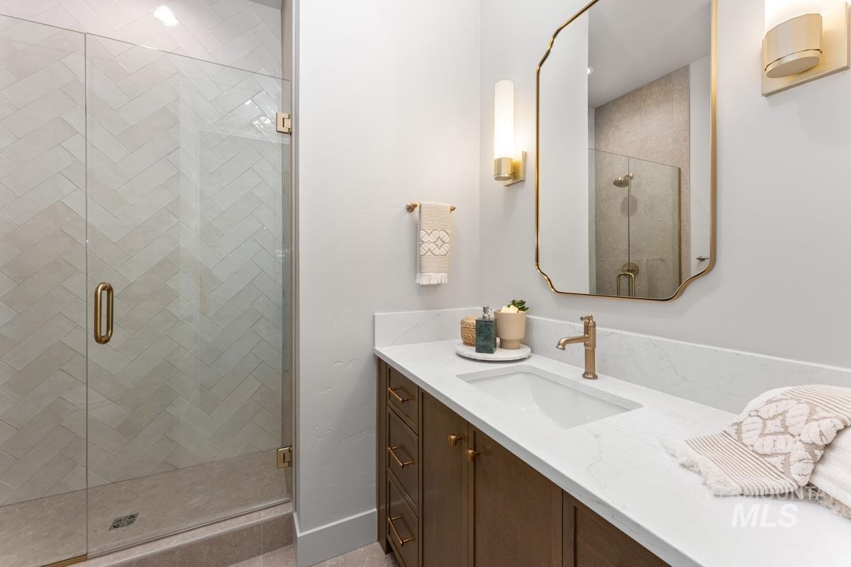 Bathroom with a stall shower and vanity