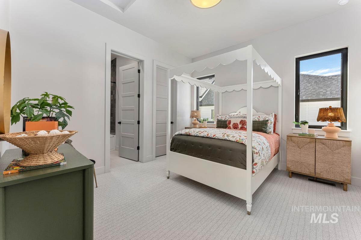 Bedroom featuring light colored carpet