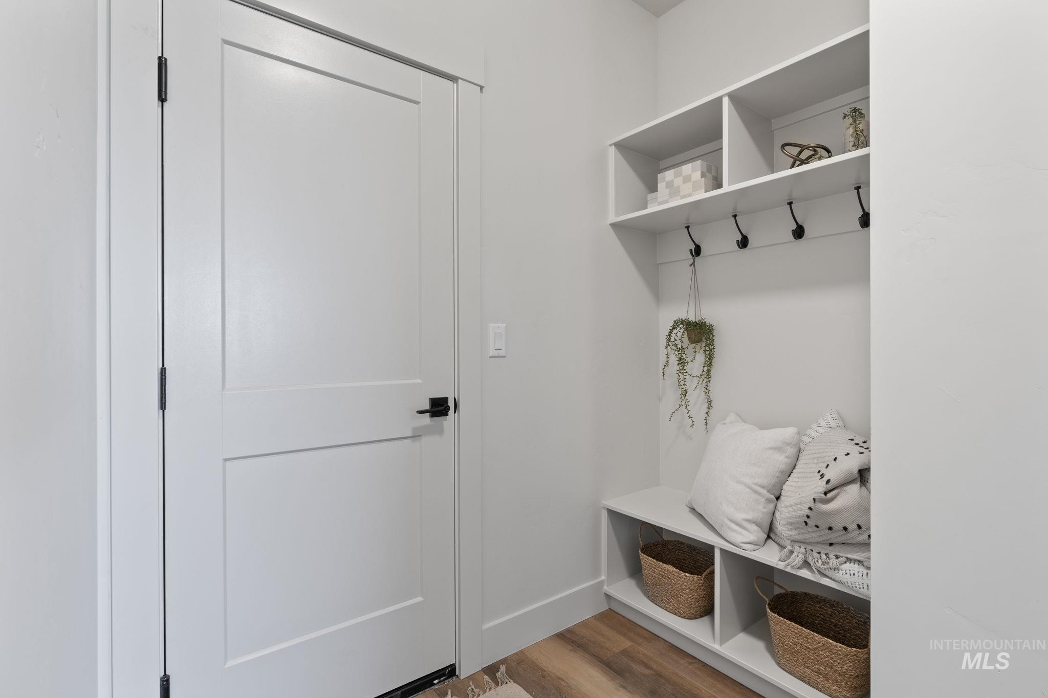 Mudroom featuring wood finished floors and baseboards