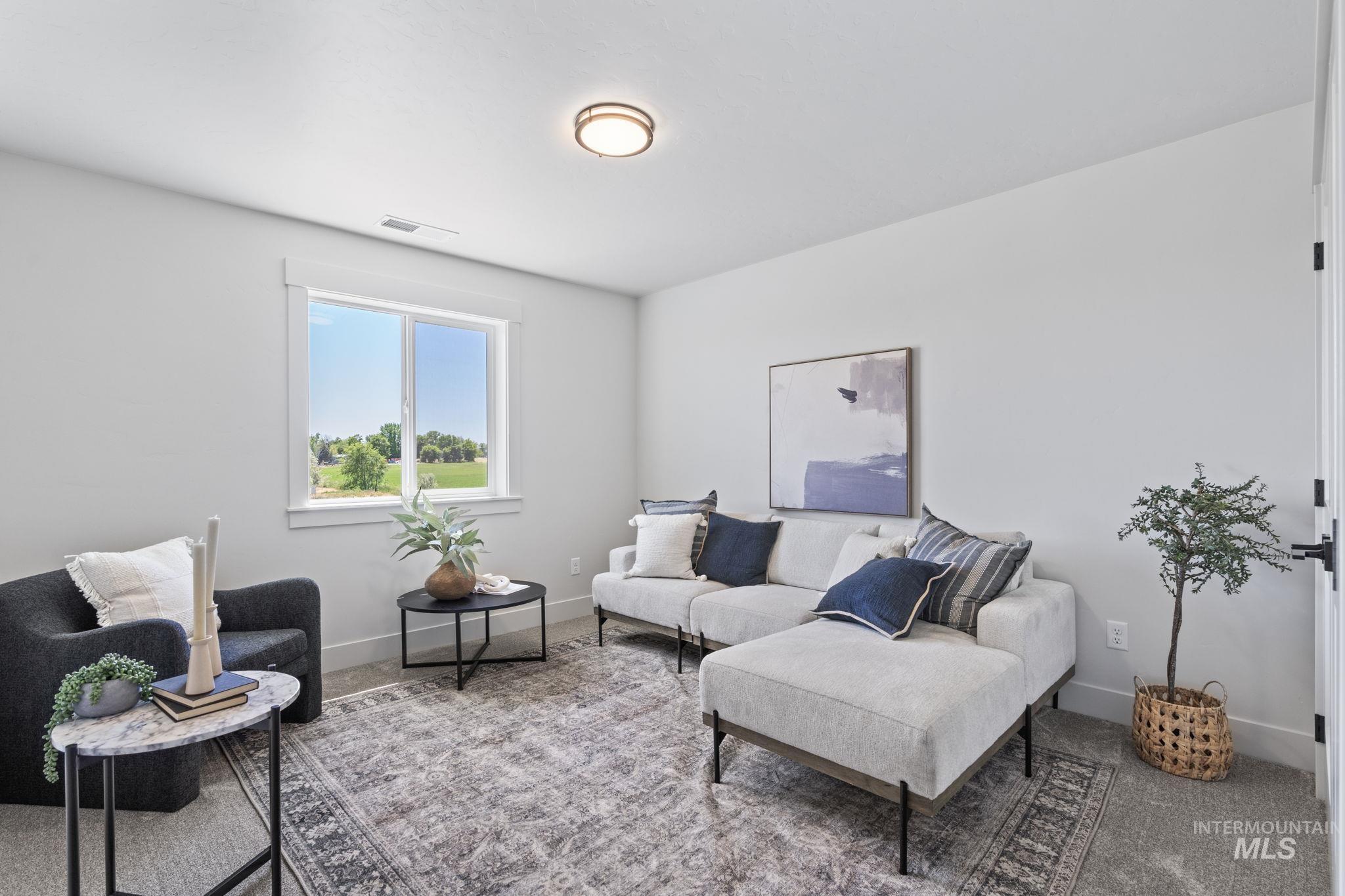 Living area with carpet and baseboards