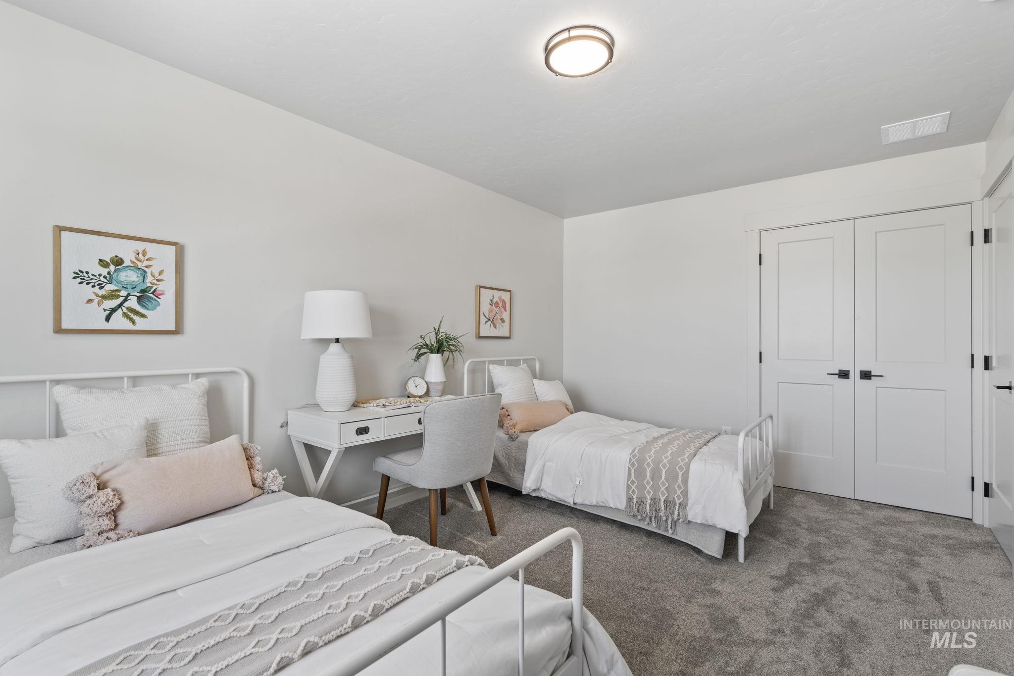 Carpeted bedroom with a closet