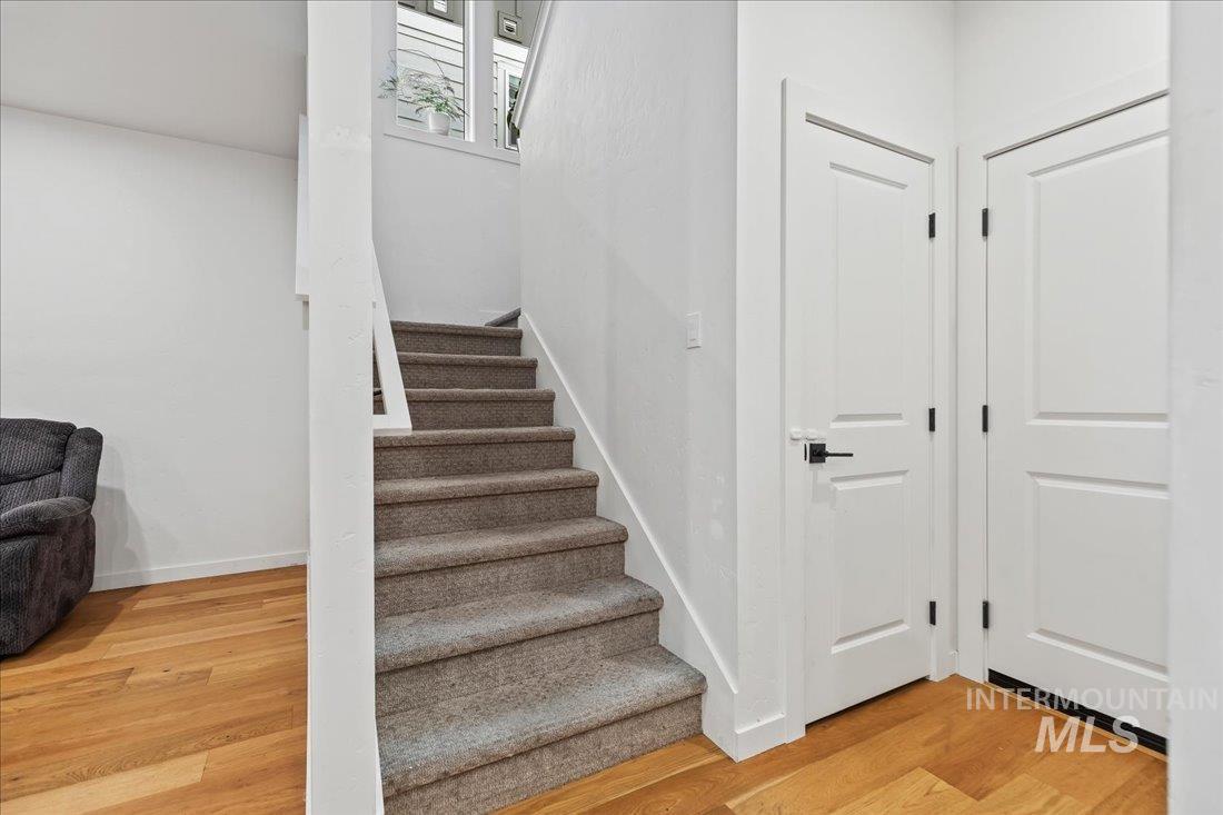 Staircase featuring wood finished floors and baseboards