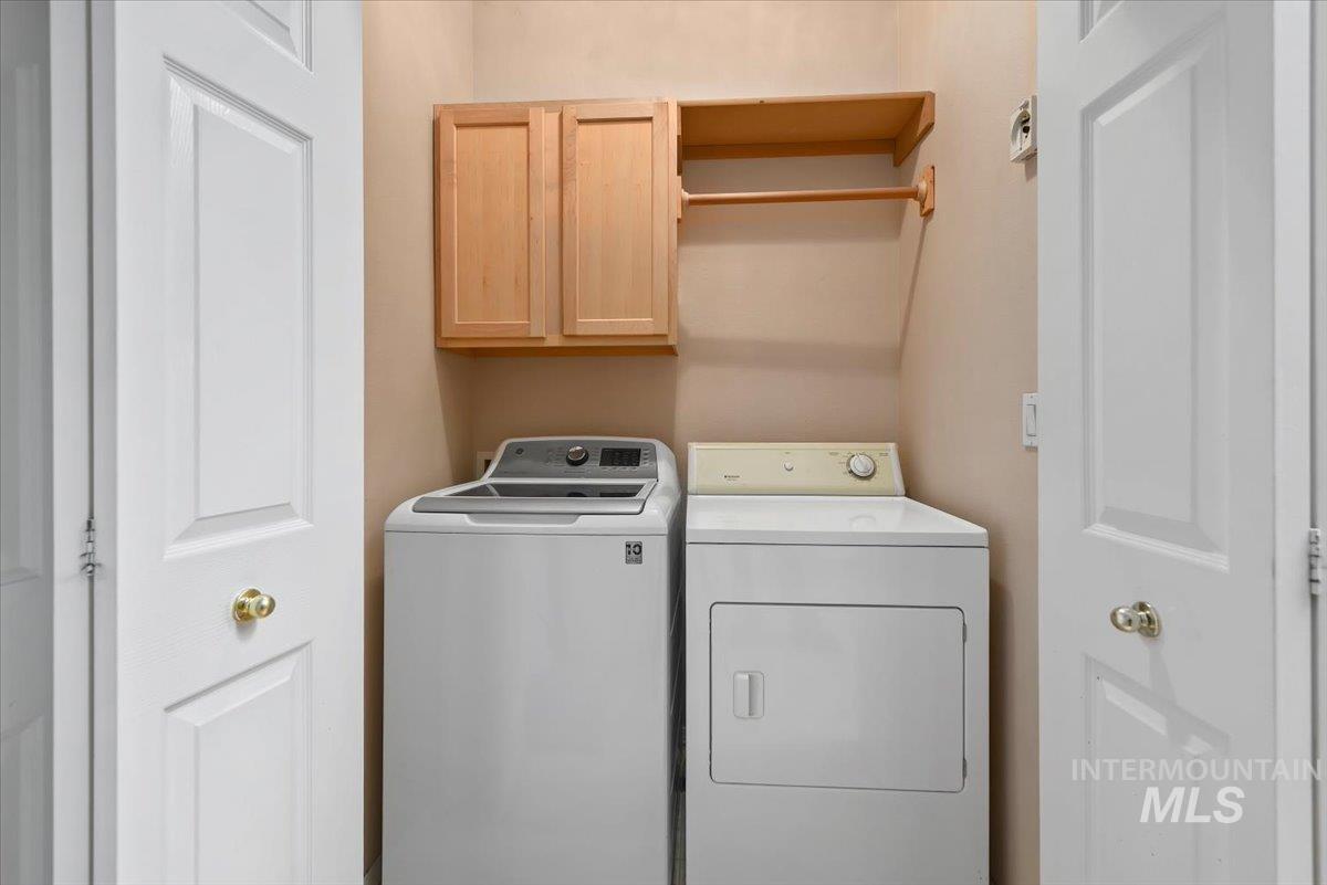 Laundry room with cabinet space and independent washer and dryer