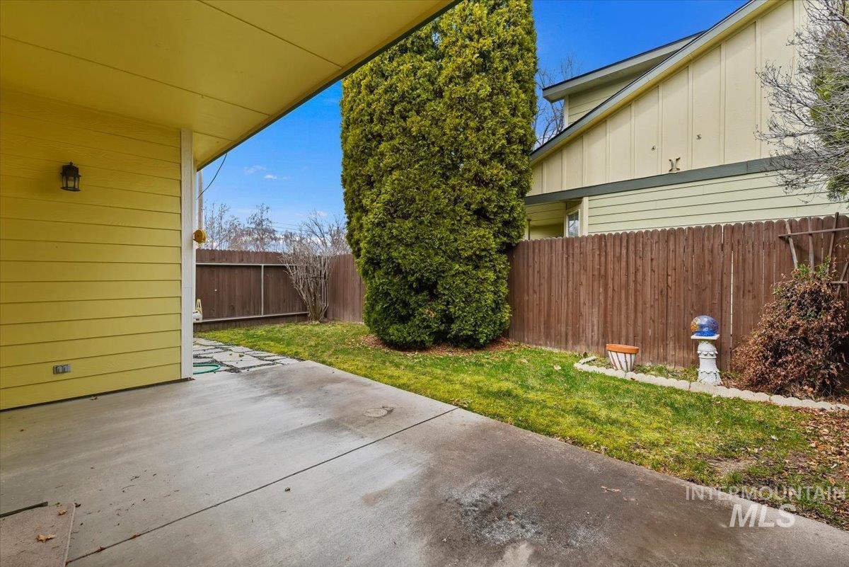 Fenced backyard featuring a patio