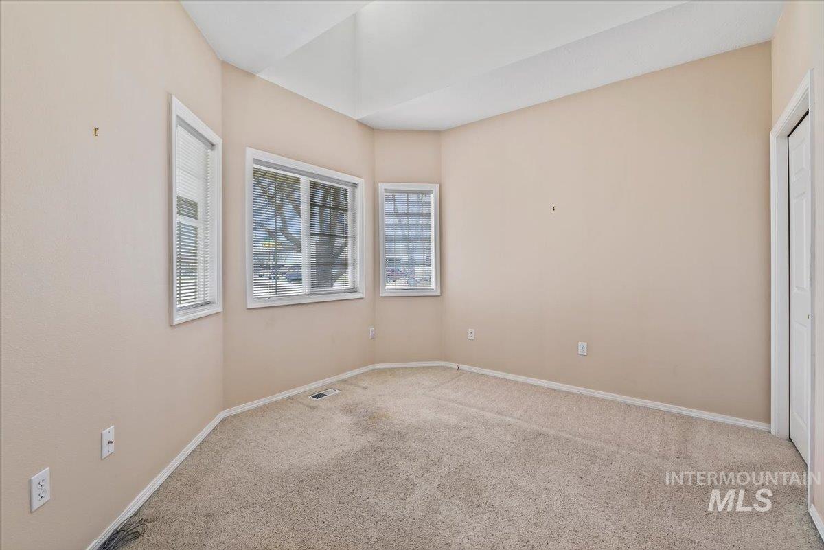 Carpeted empty room with baseboards