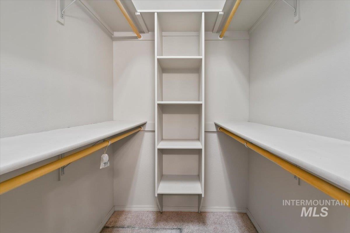 Walk in closet featuring light carpet