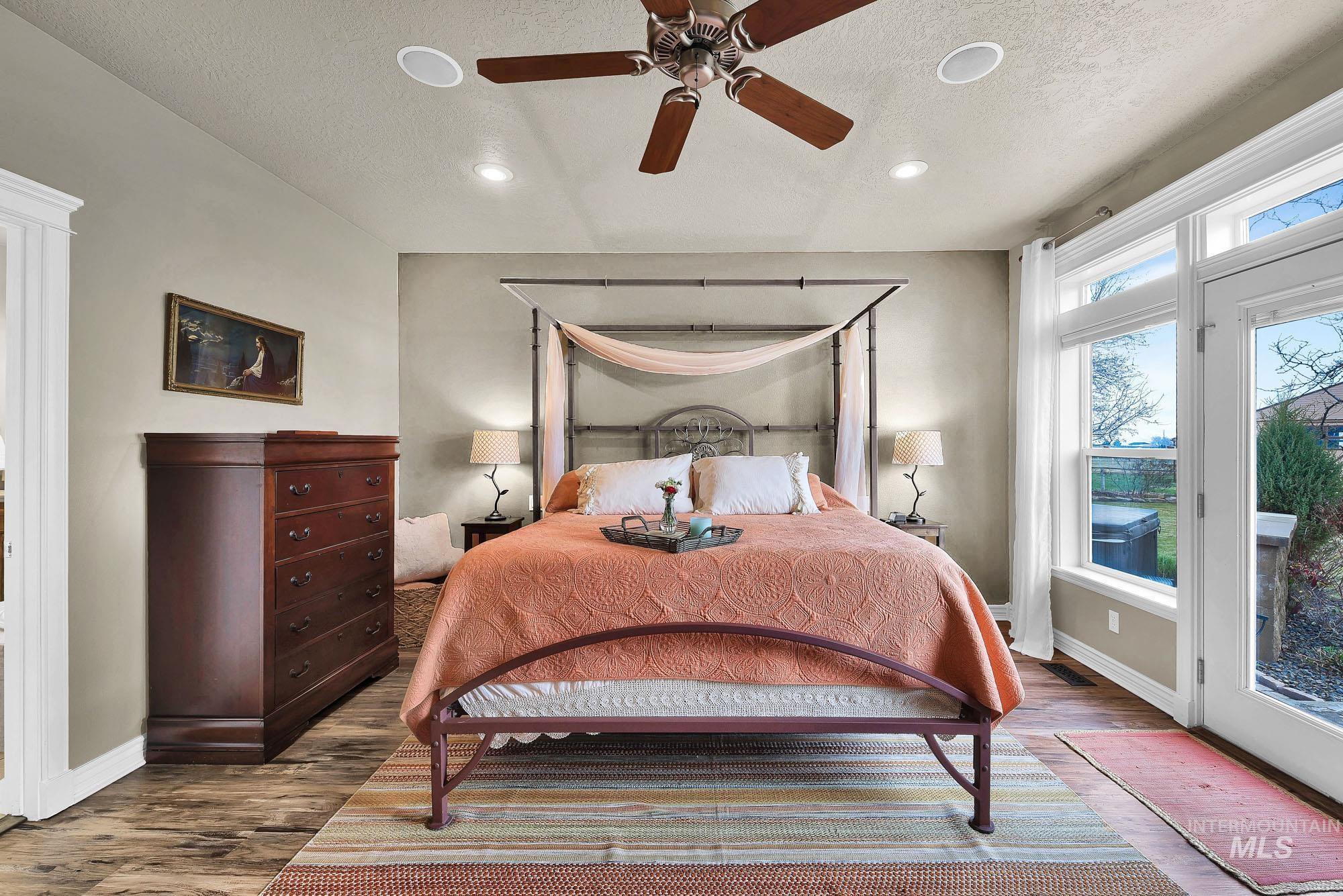 Bedroom featuring access to outside, wood finished floors, recessed lighting, a textured ceiling, and a ceiling fan
