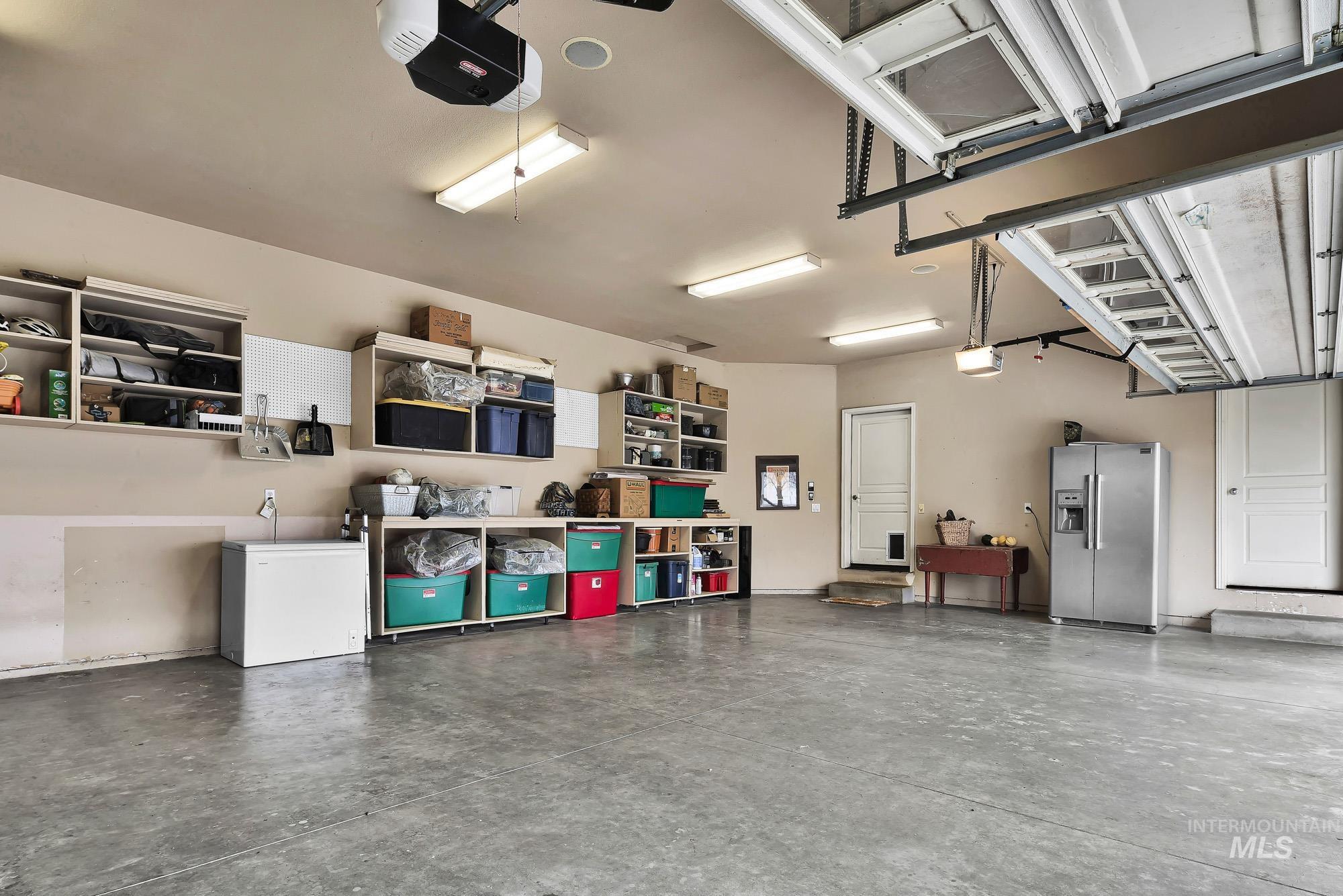 3 car Garage with built in shelving, fully painted and insulated with a garage door opener