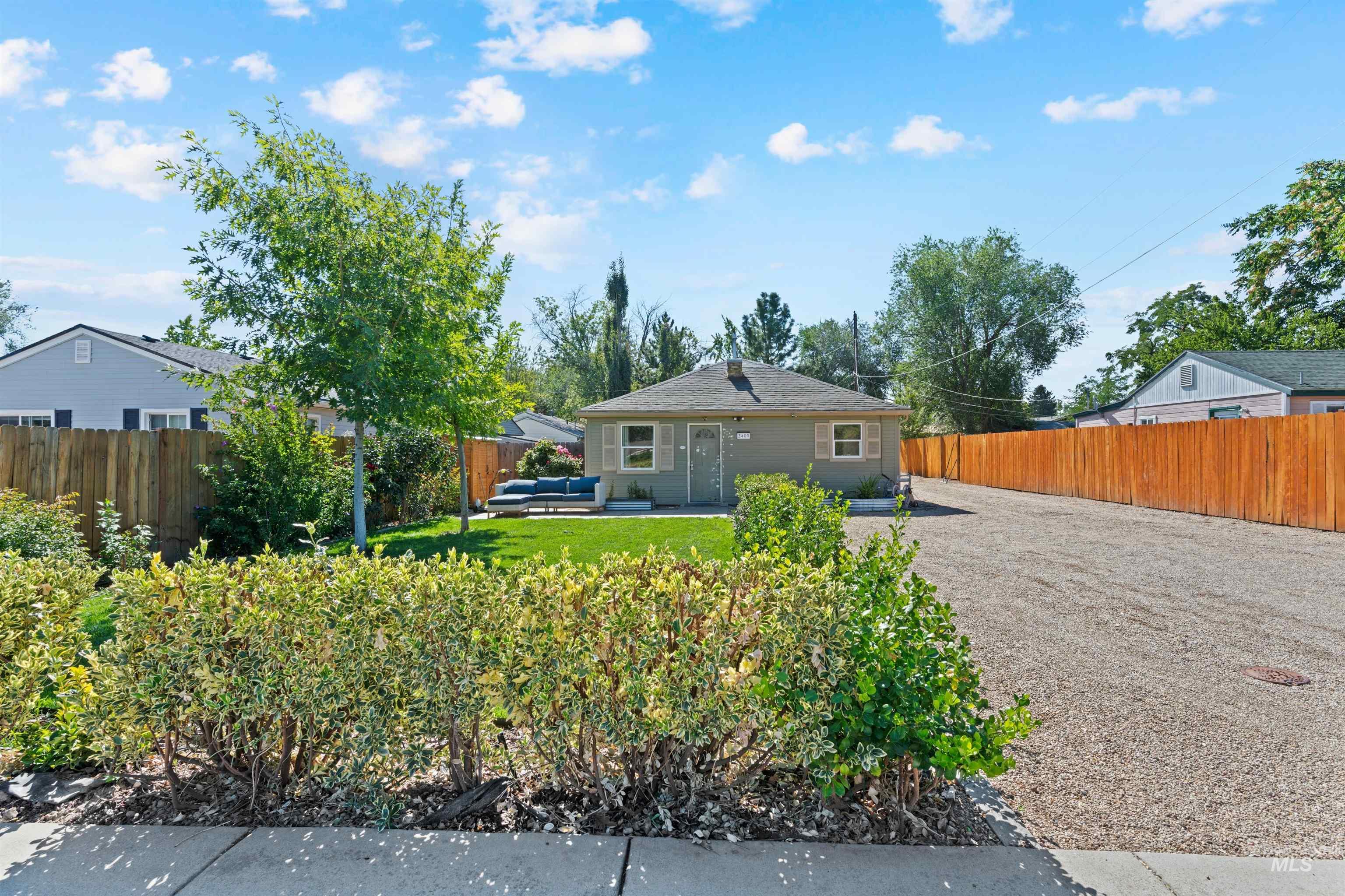 Back of property with a fenced backyard, an outdoor hangout area, and a patio