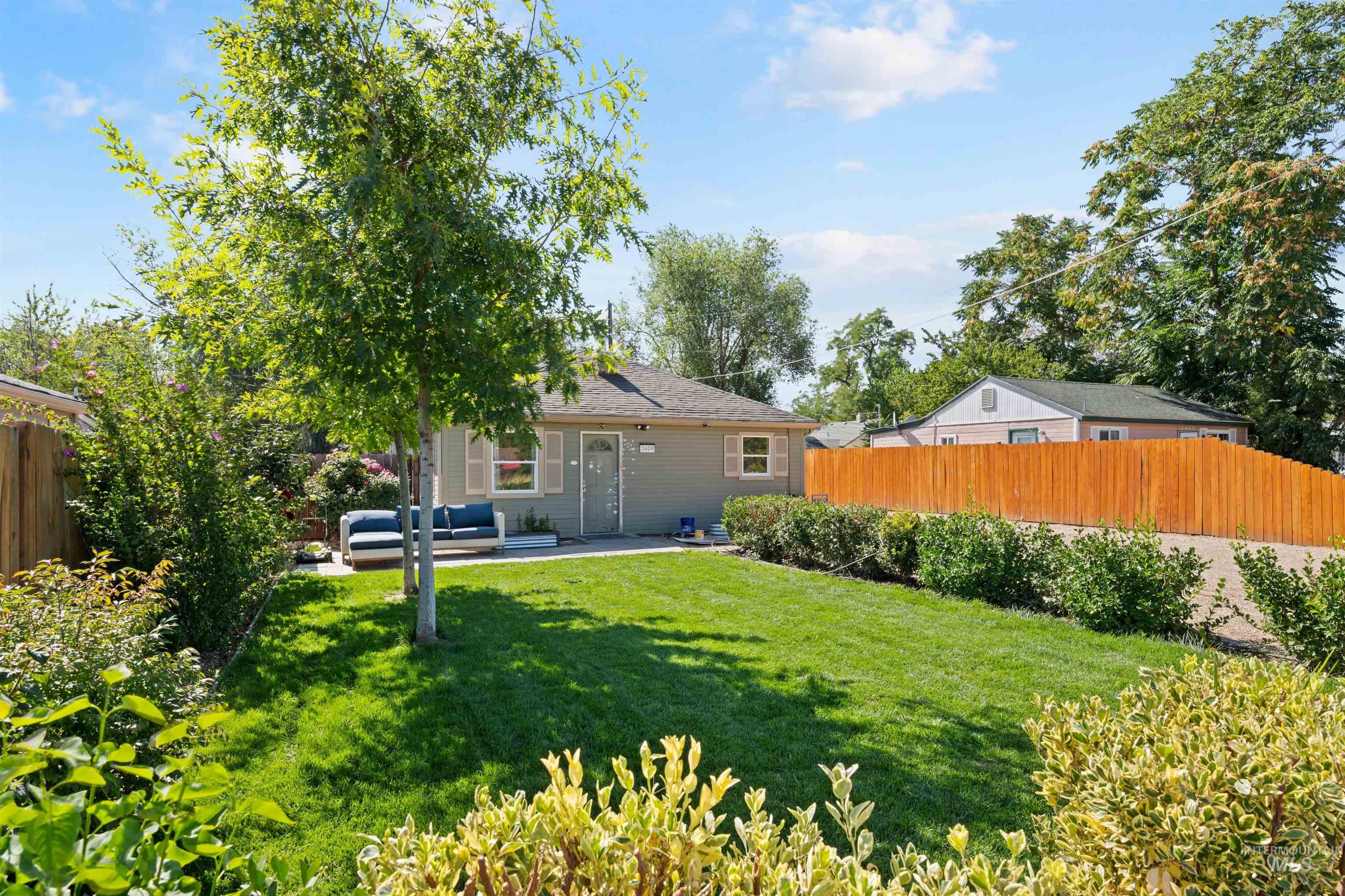 Back of house with a fenced backyard, a patio area, an outdoor hangout area, and a shingled roof