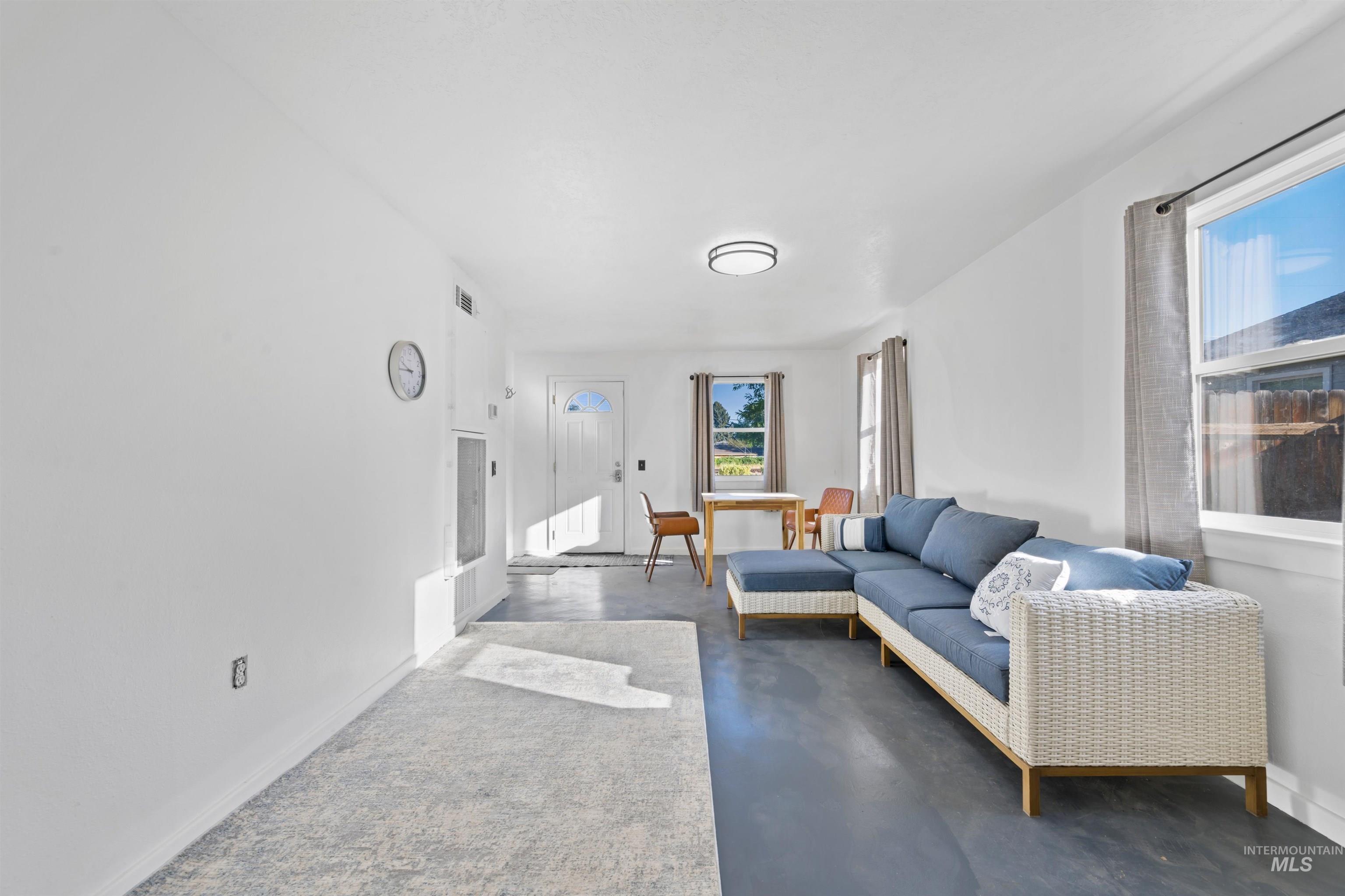 Living area featuring healthy amount of natural light and finished concrete flooring