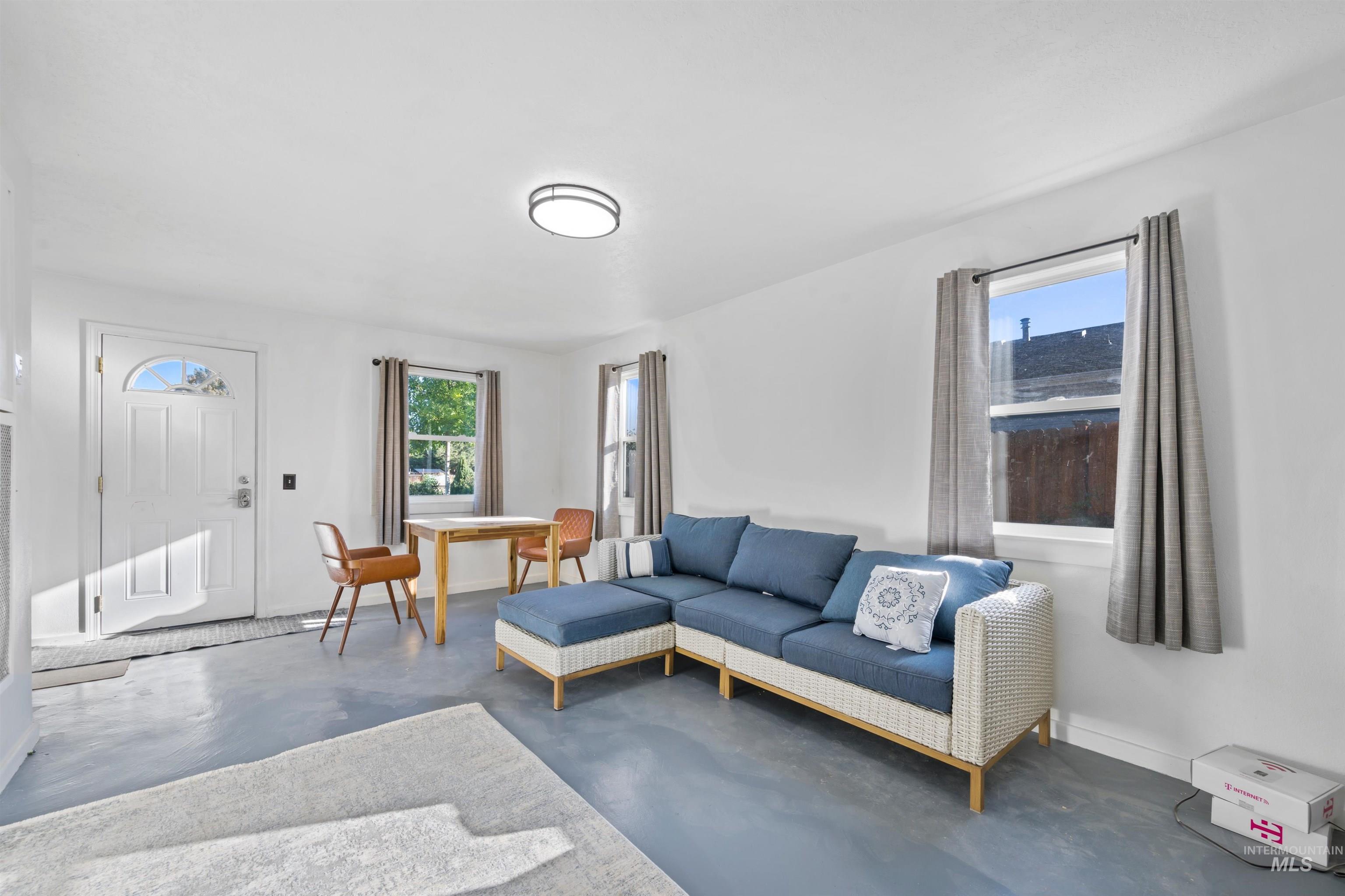 Living area featuring healthy amount of natural light and concrete floors