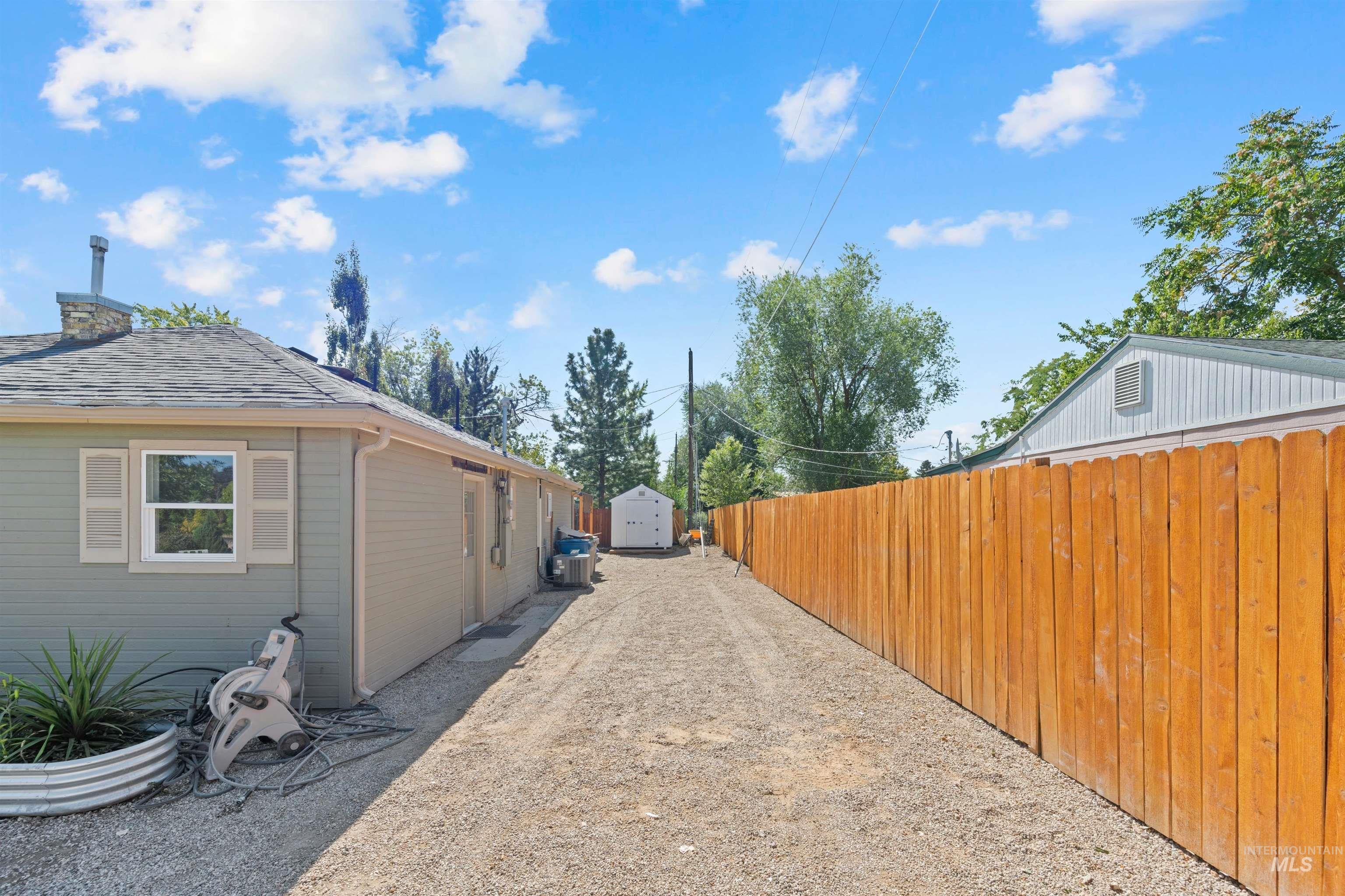 View of home's exterior featuring a shed and a chimney
