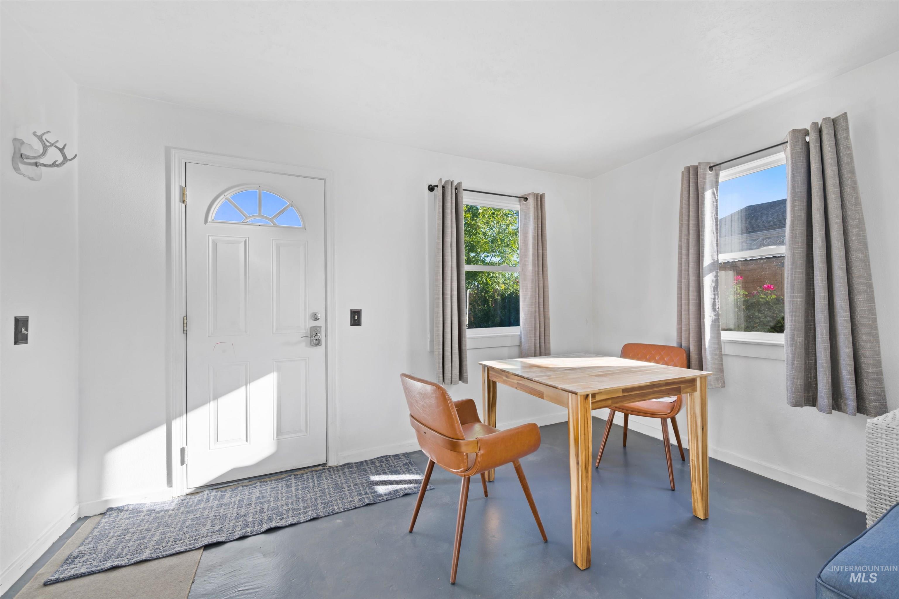 Dining area featuring finished concrete floors