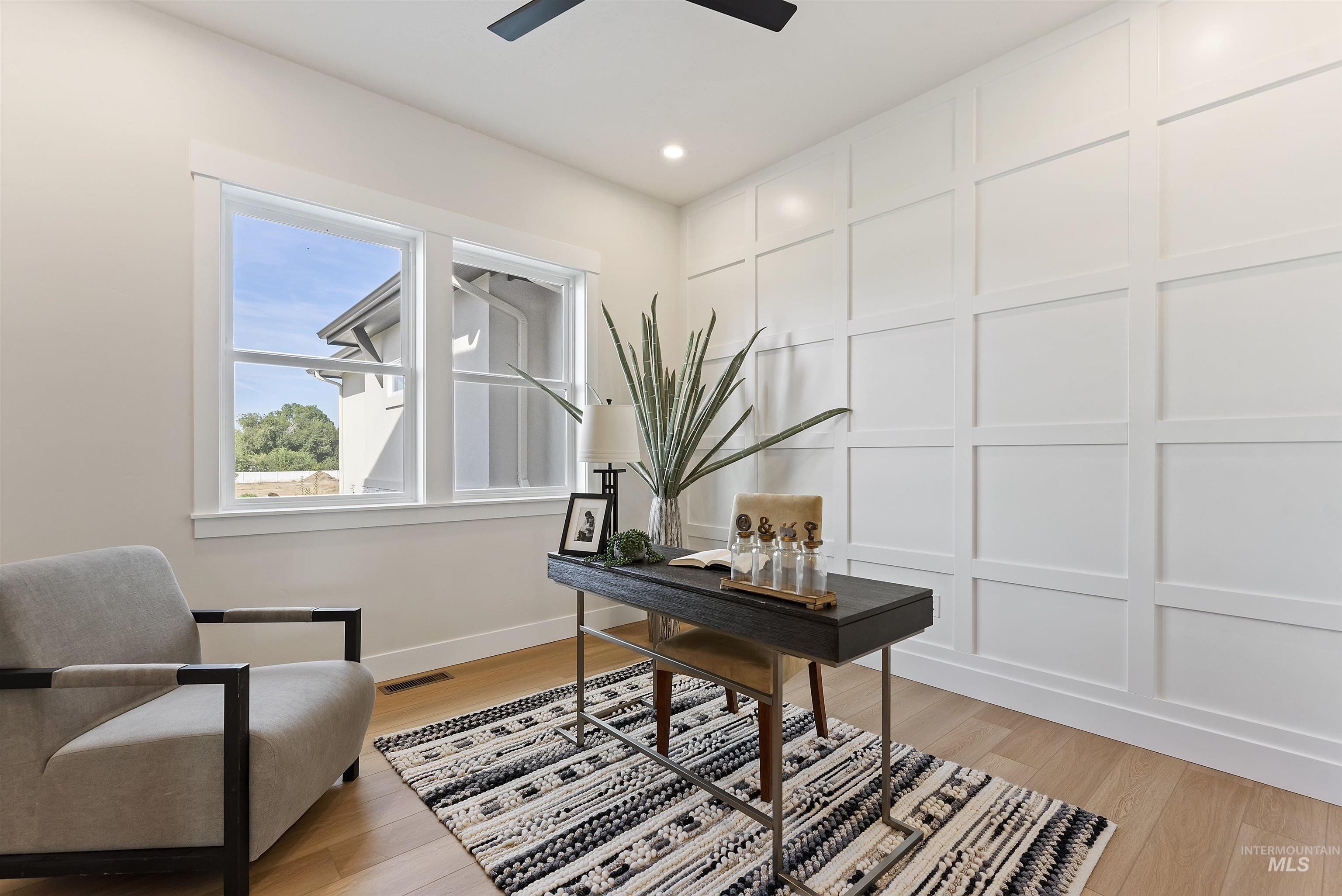 Office featuring a decorative wall, light wood-style flooring, and recessed lighting
