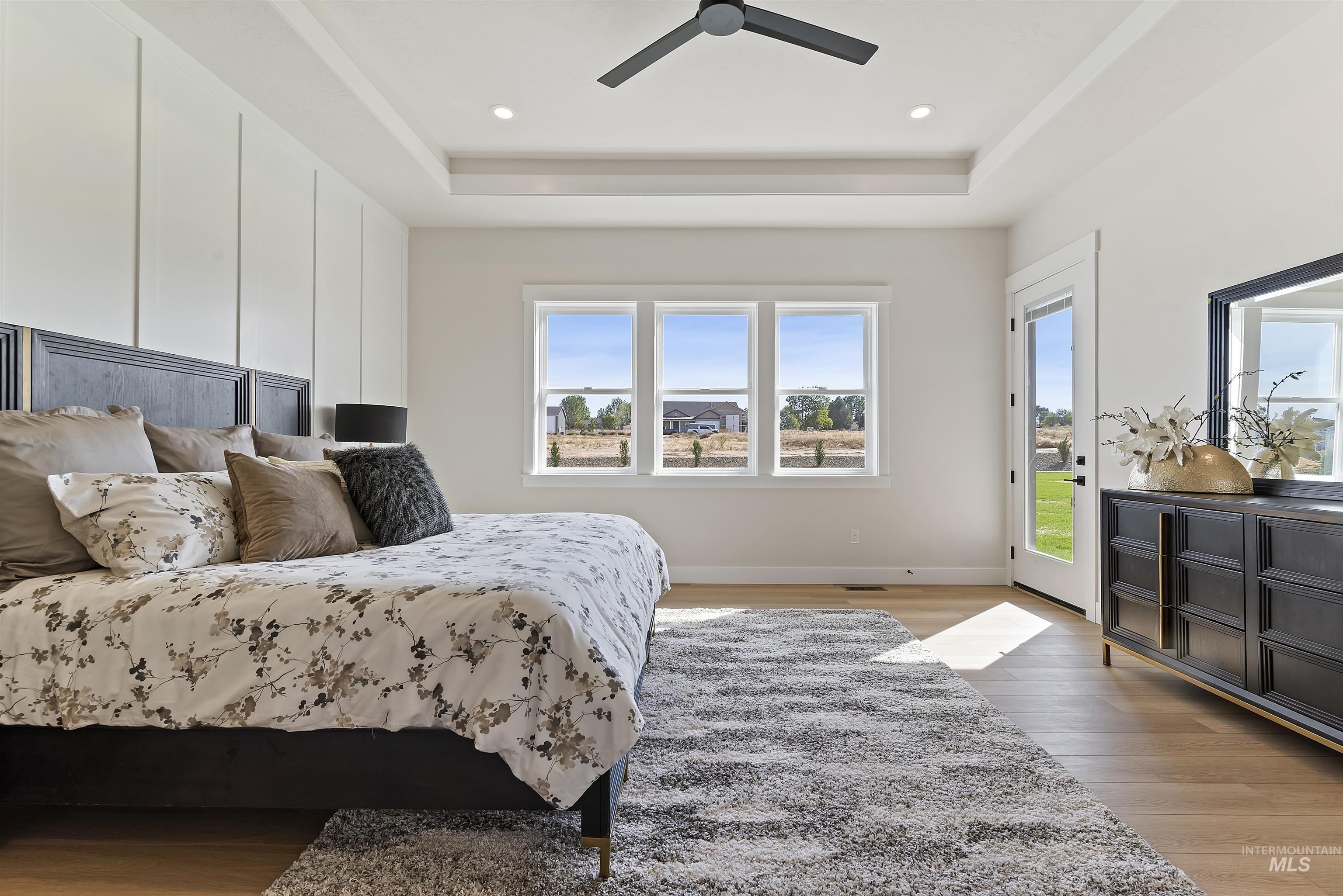 Bedroom with multiple windows, light wood-type flooring, access to outside, recessed lighting, and a ceiling fan