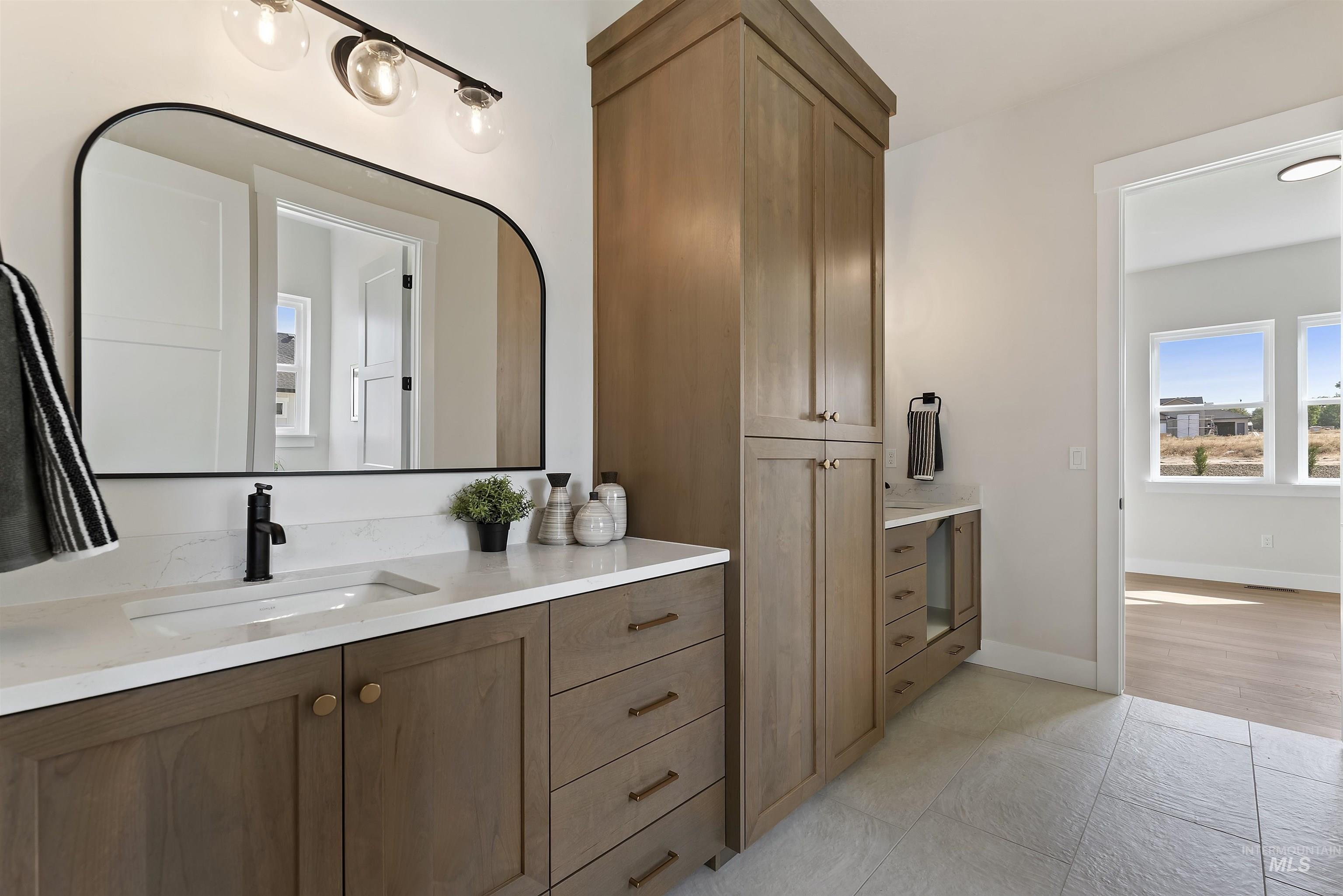 Bathroom featuring vanity and light tile patterned flooring
