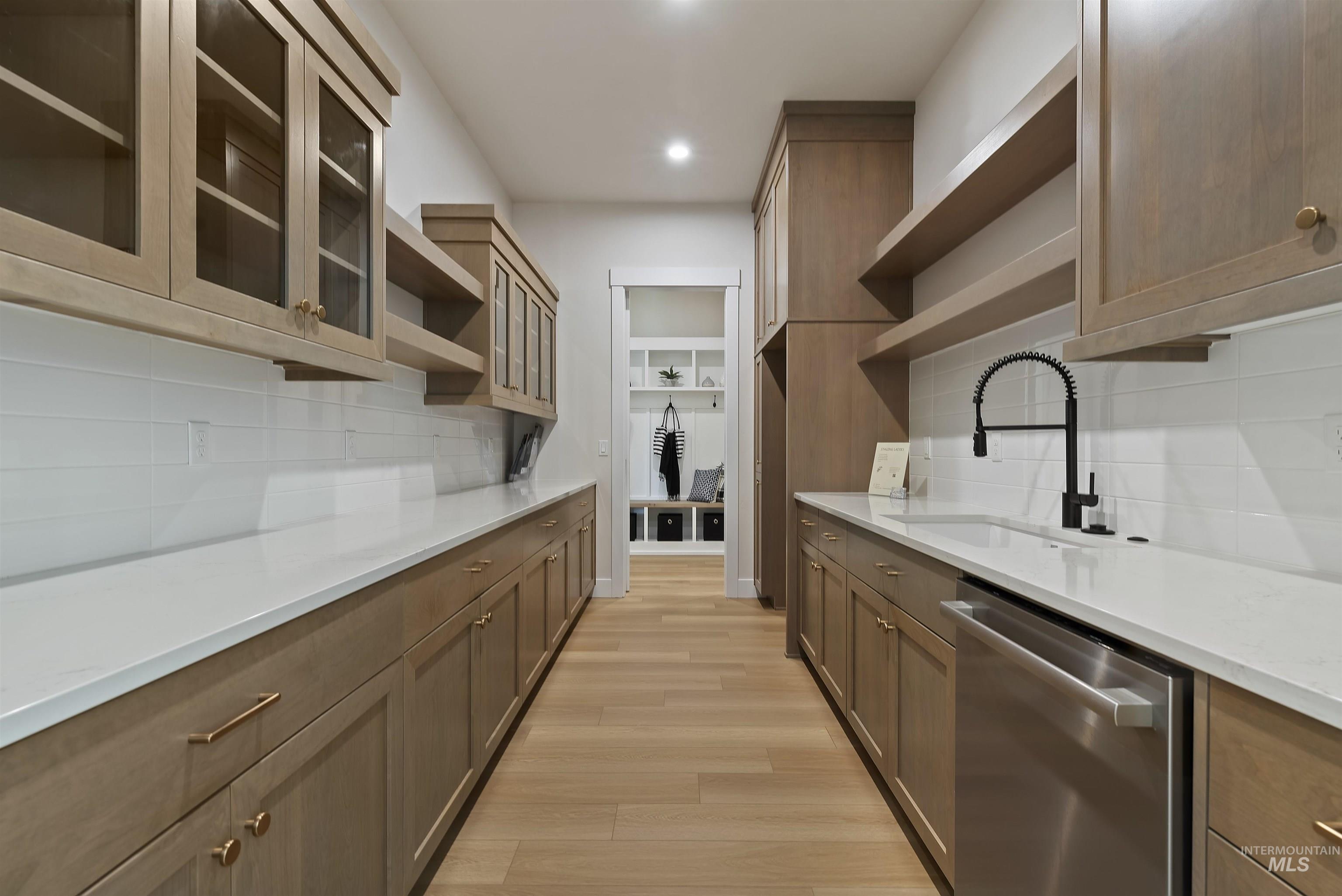 Kitchen featuring open shelves, tasteful backsplash, dishwasher, glass insert cabinets, and recessed lighting