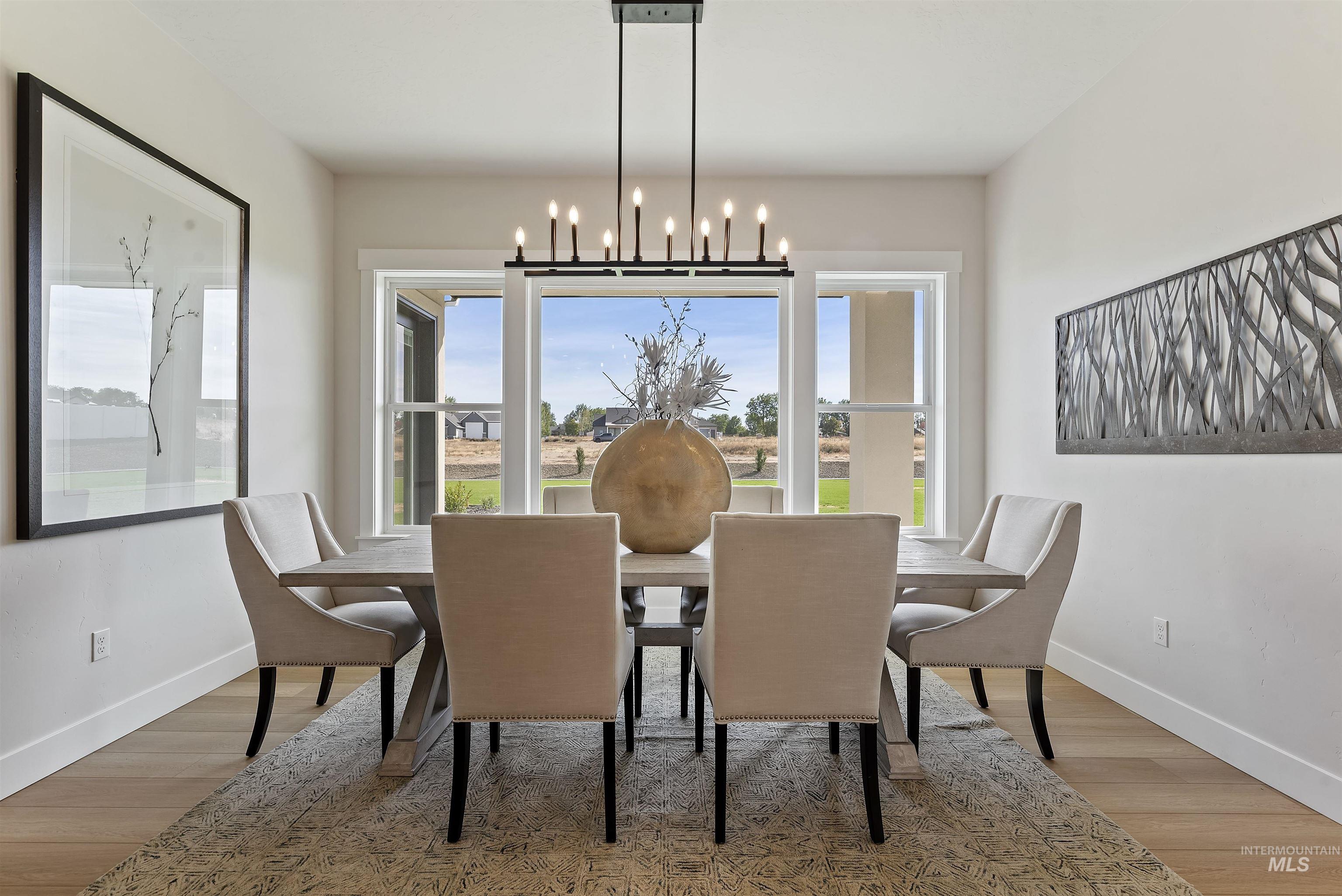 Dining space featuring light wood-style flooring and a chandelier
