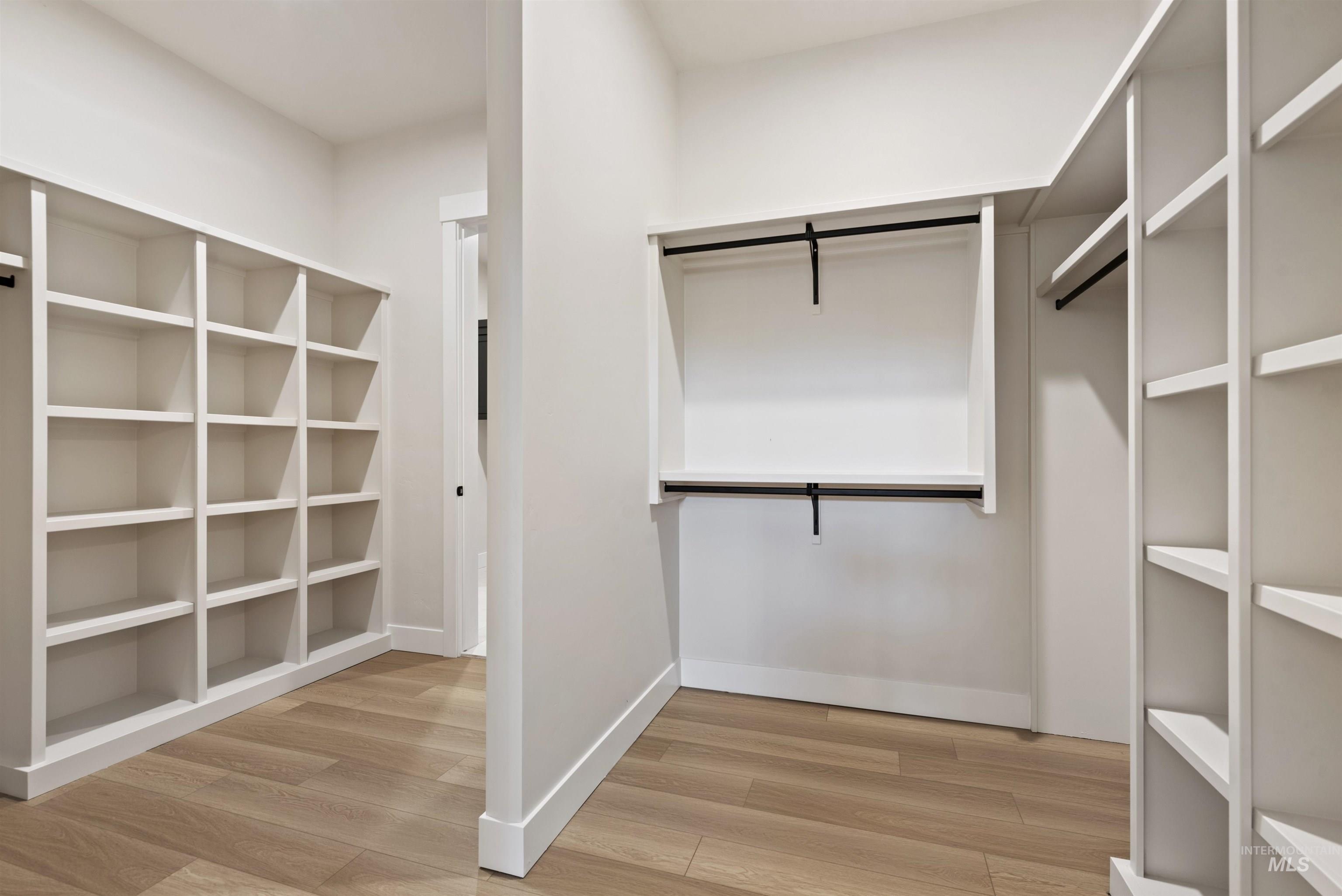 Spacious closet with light wood-type flooring