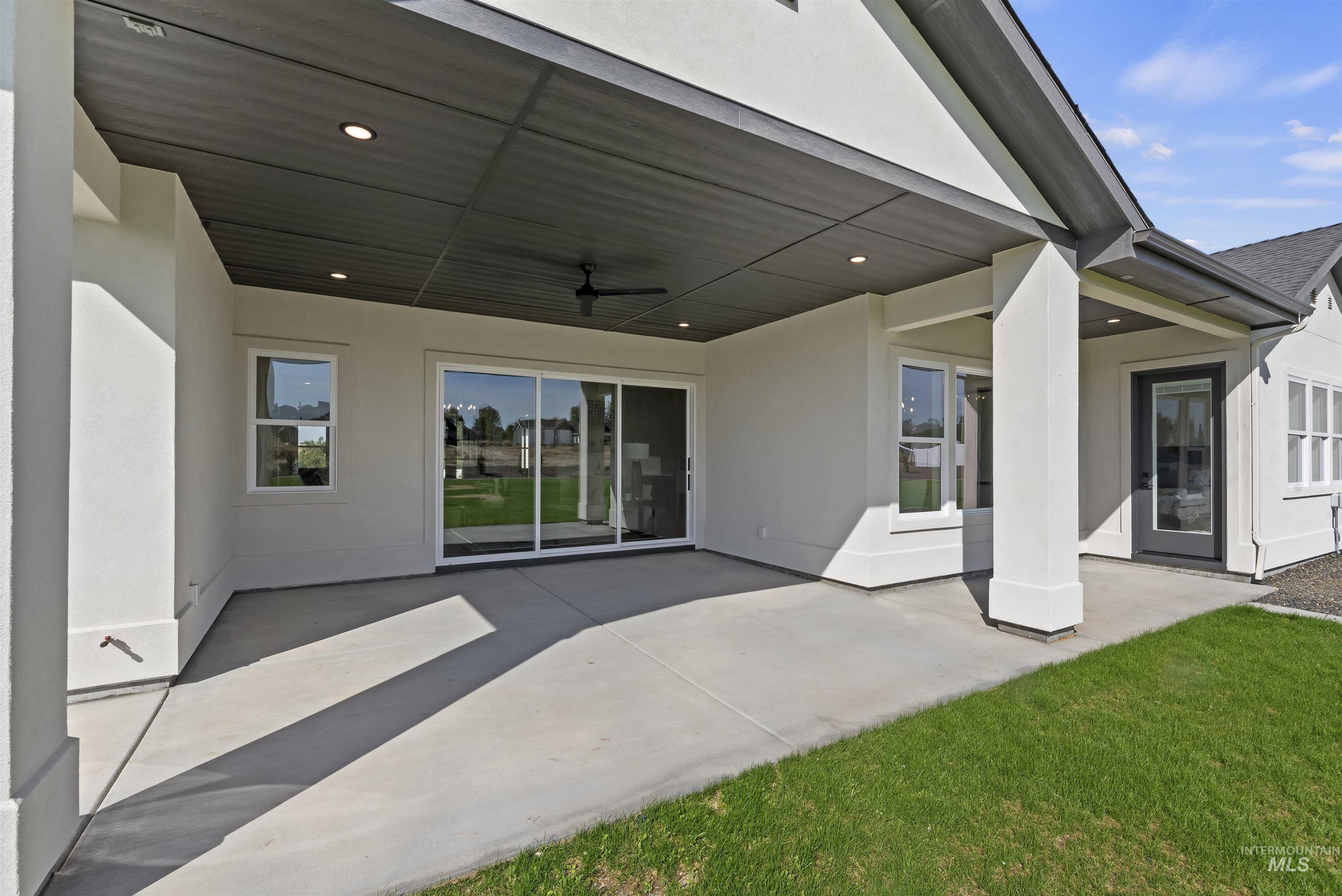 Back of property featuring stucco siding and a patio area