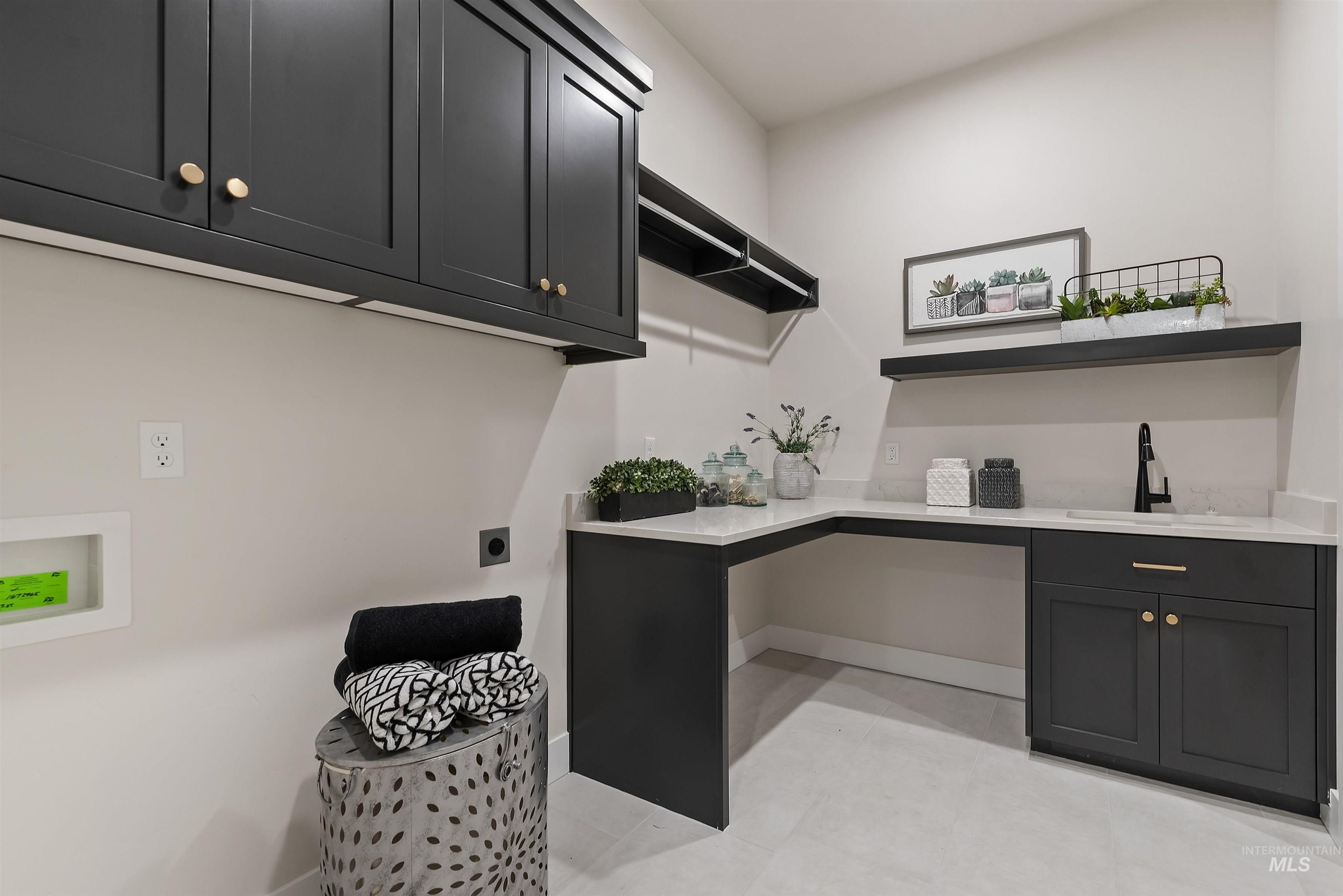 Washroom with cabinet space, light tile patterned floors, washer hookup, and electric dryer hookup