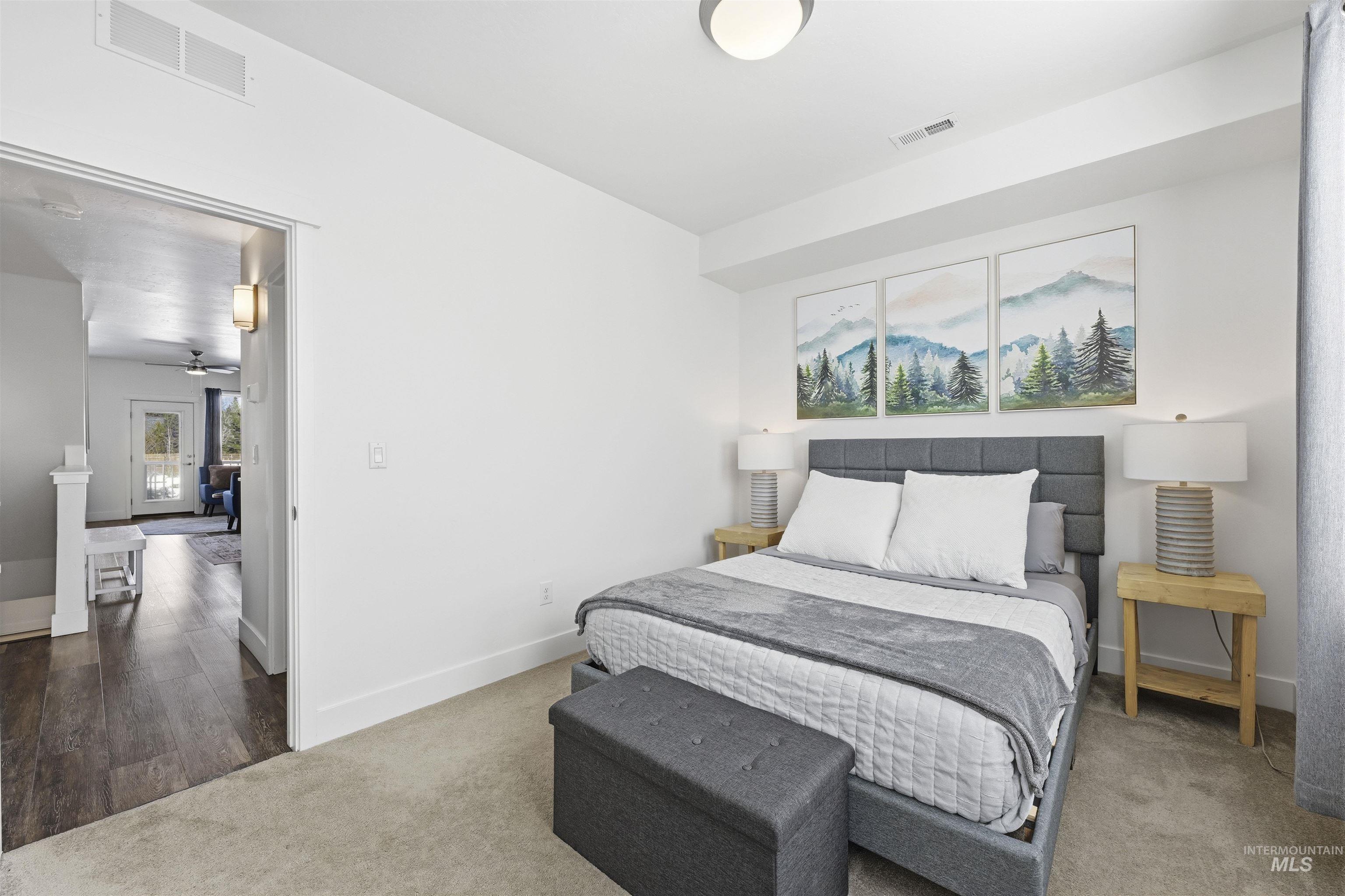 Bedroom featuring carpet flooring and baseboards