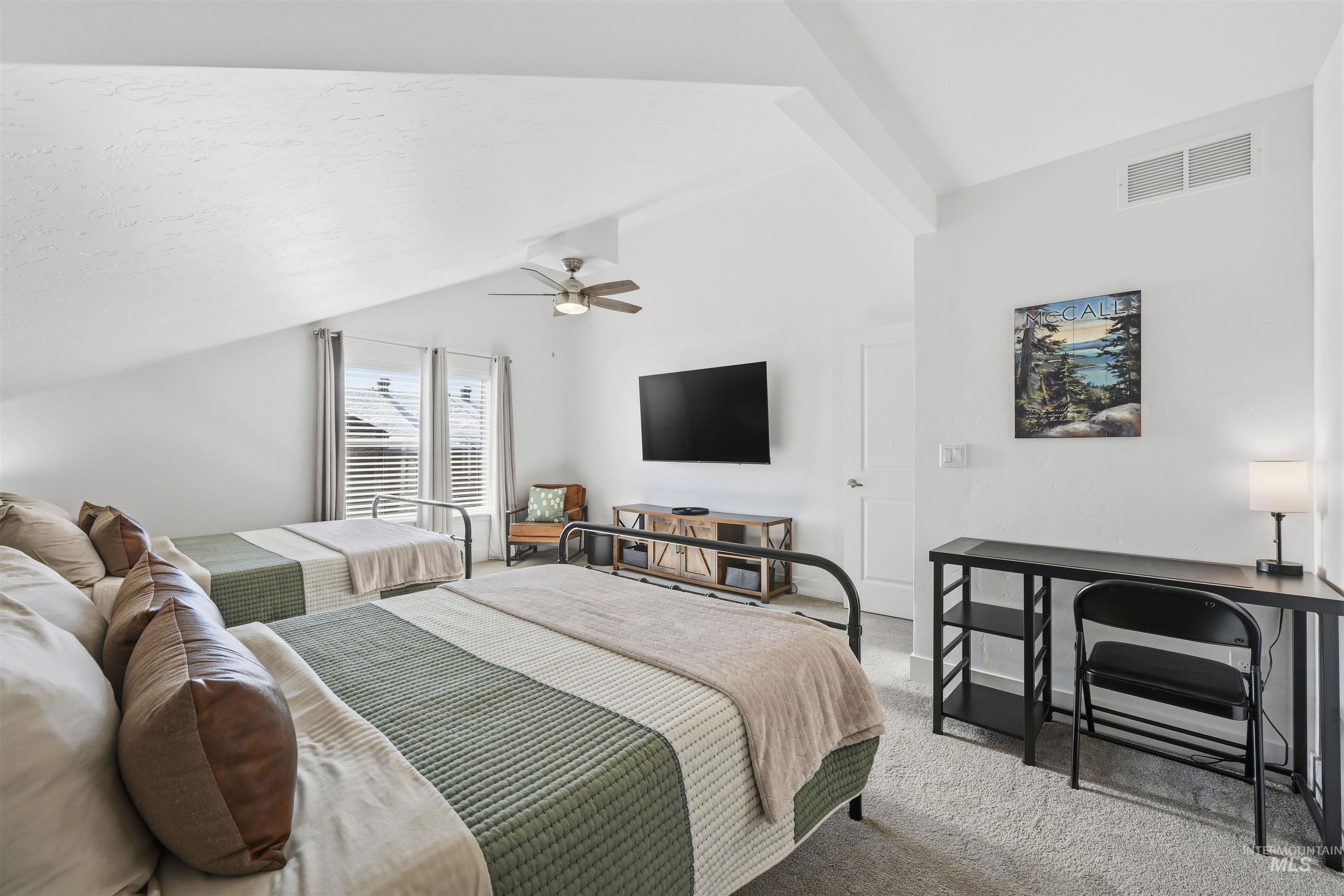 Bedroom featuring carpet flooring, lofted ceiling, and ceiling fan