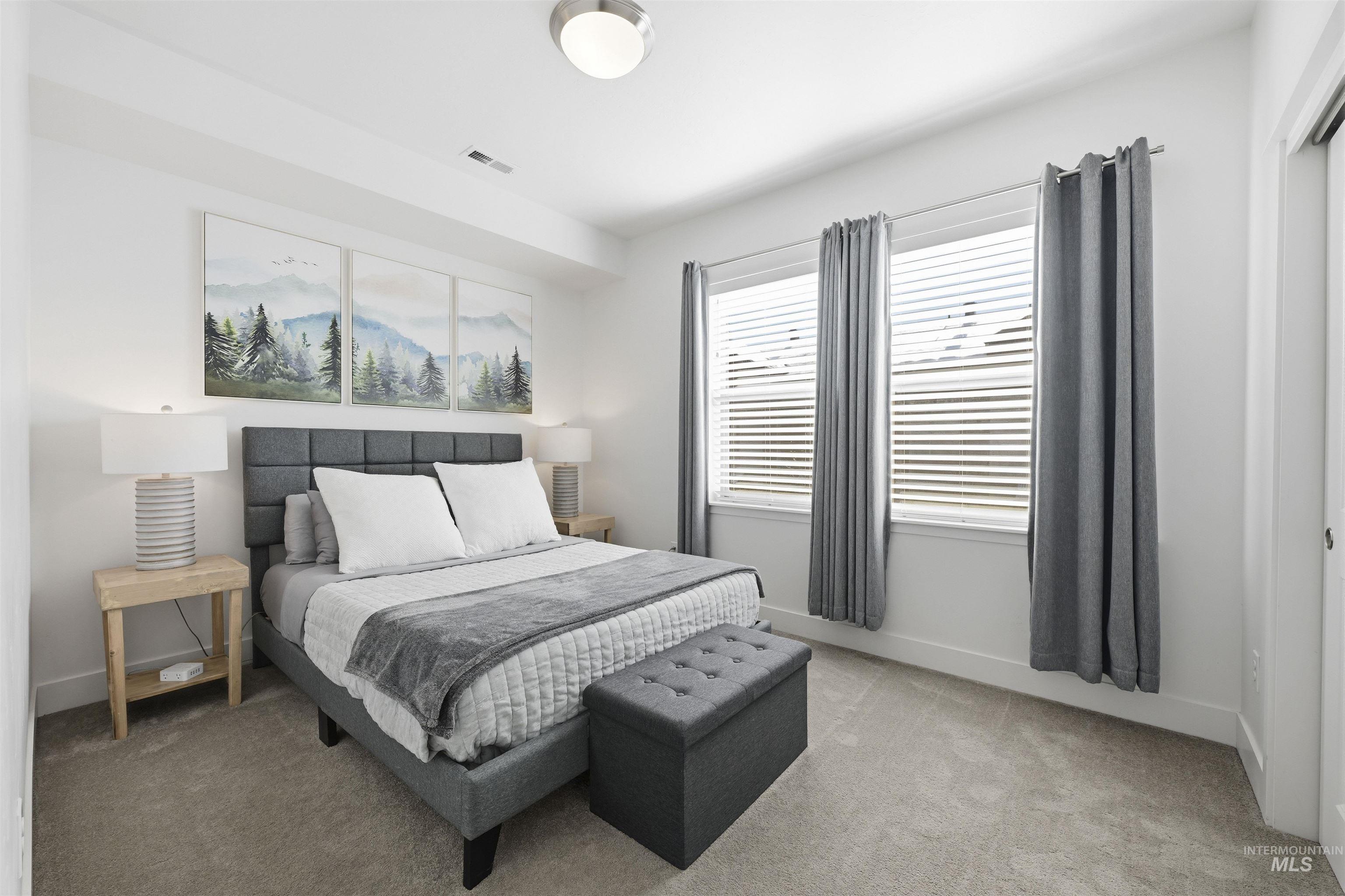 Bedroom with light carpet and baseboards