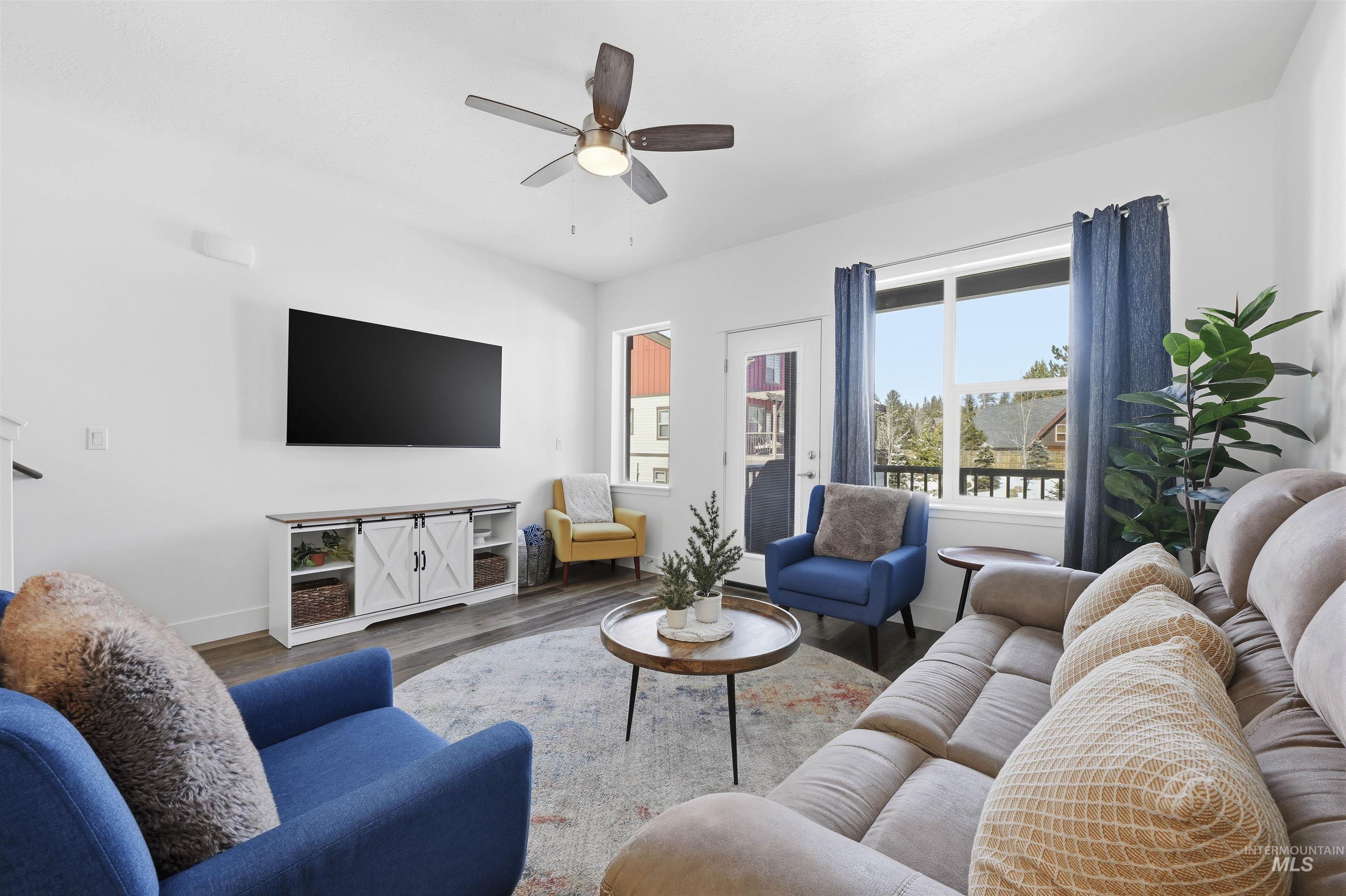 Living area with wood finished floors and ceiling fan