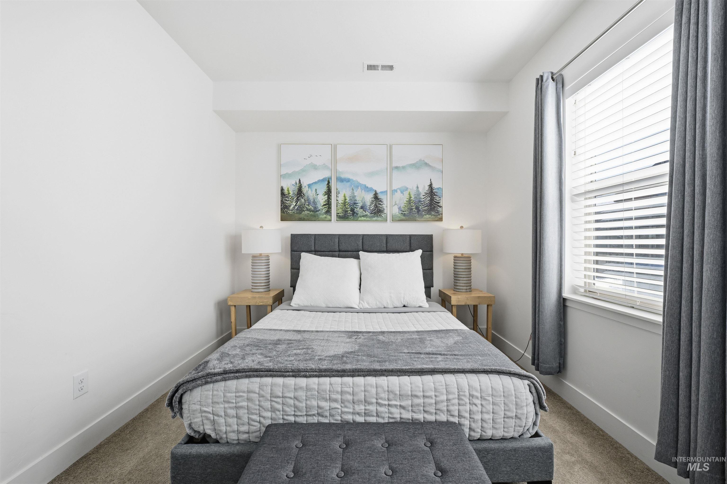 Bedroom with carpet floors and multiple windows