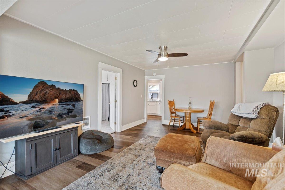 Living area featuring wood finished floors and ceiling fan